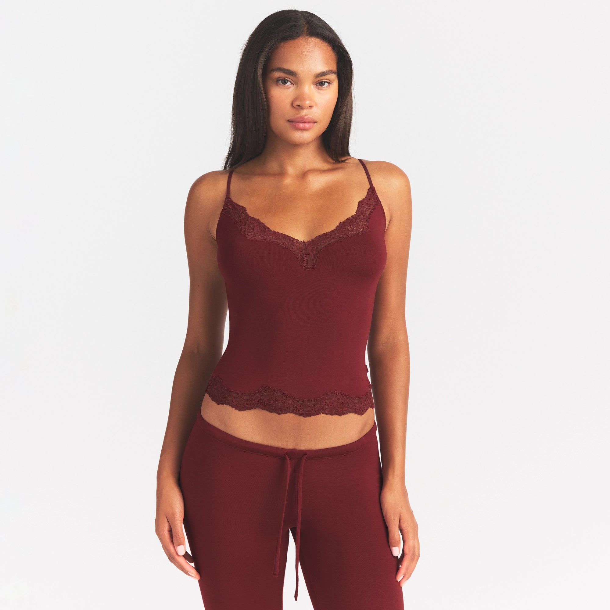 SKIMS SLEEP LACE CAMI AND PANT SLEEP SET | MERLOT ON A MODEL SIDE VIEW @ | FOCUS: 0.0, 1.0, 0.9