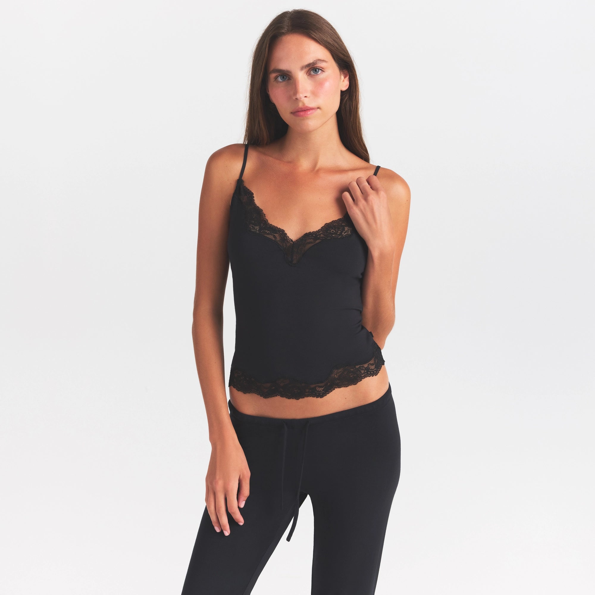 SKIMS SLEEP LACE CAMI AND PANT SET | ONYX ON A MODEL SIDE VIEW @ | FOCUS: 0.0, 1.0, 0.9