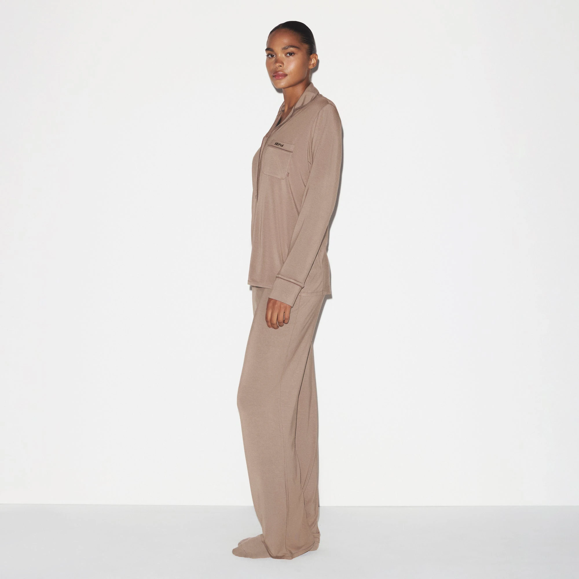 SKIMS SLEEP LONG SLEEVE BUTTON UP SET | FOSSIL ON A MODEL SIDE VIEW @ | FOCUS: 0.0, 1.0, 0.9