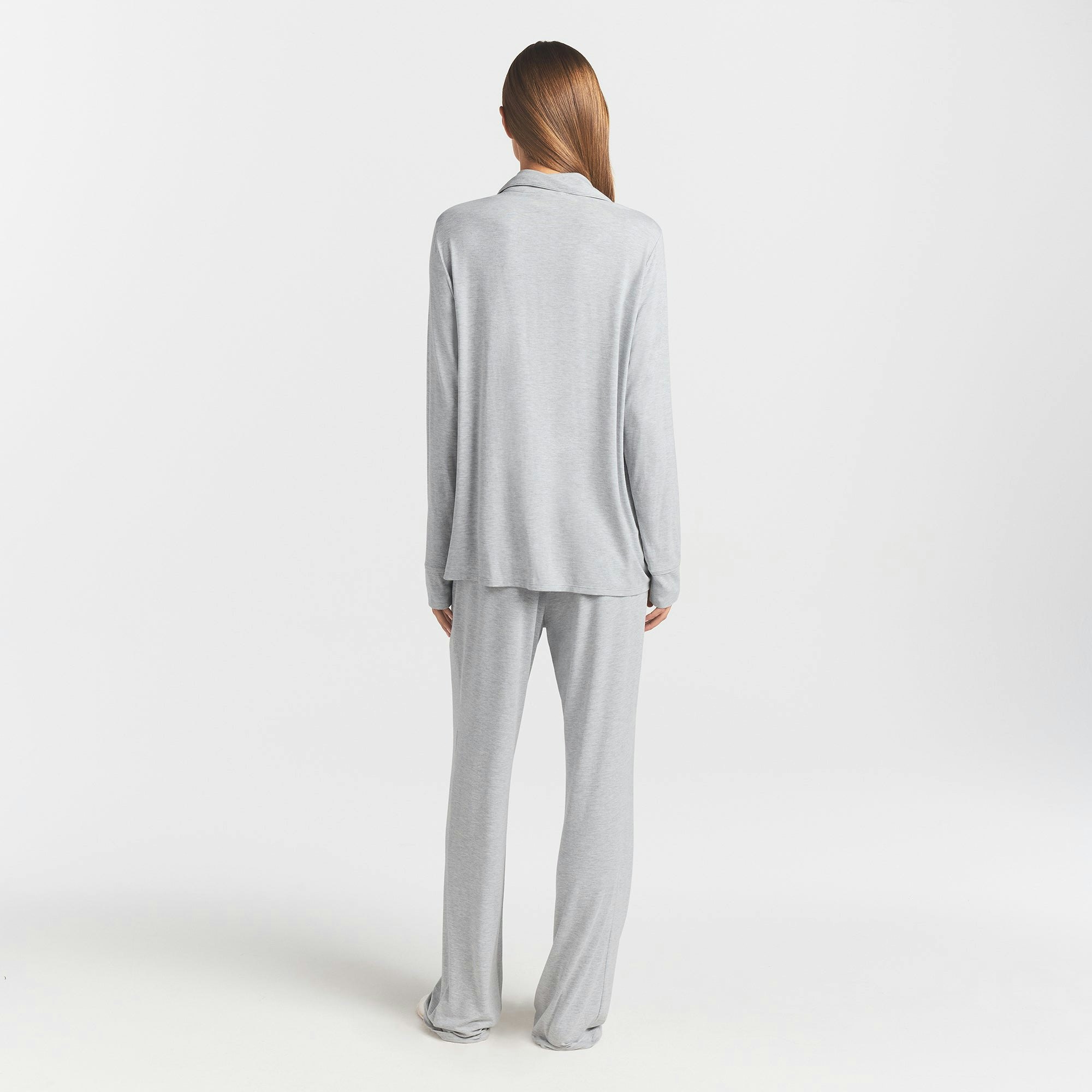 SKIMS SLEEP LONG SLEEVE BUTTON UP SET | LIGHT HEATHER GREY ON A MODEL BACK VIEW @ | FOCUS: 0.0, 1.0, 0.9