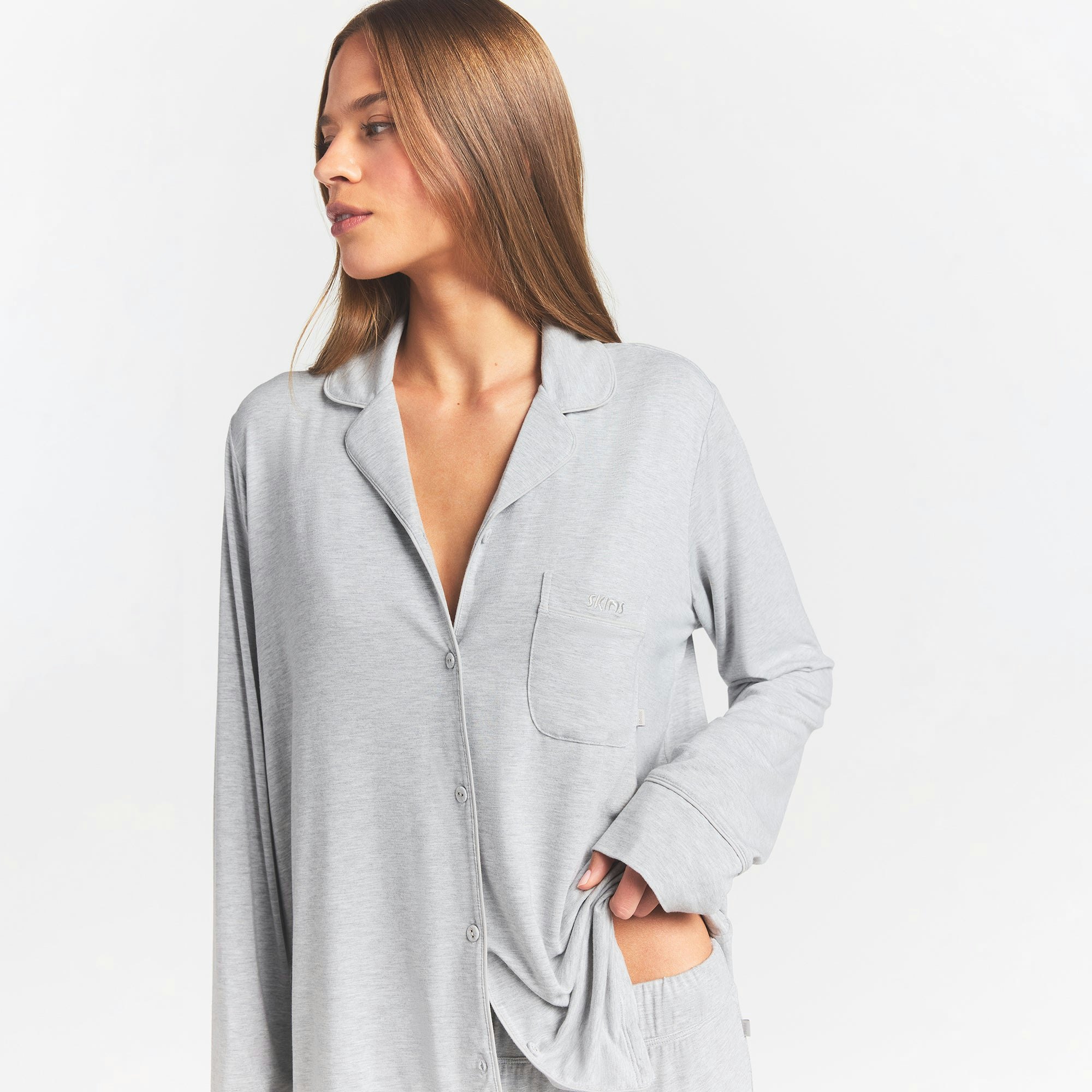 SKIMS SLEEP LONG SLEEVE BUTTON UP SET | LIGHT HEATHER GREY ON A MODEL FRONT VIEW @ | FOCUS: 0.0, 1.0, 0.9