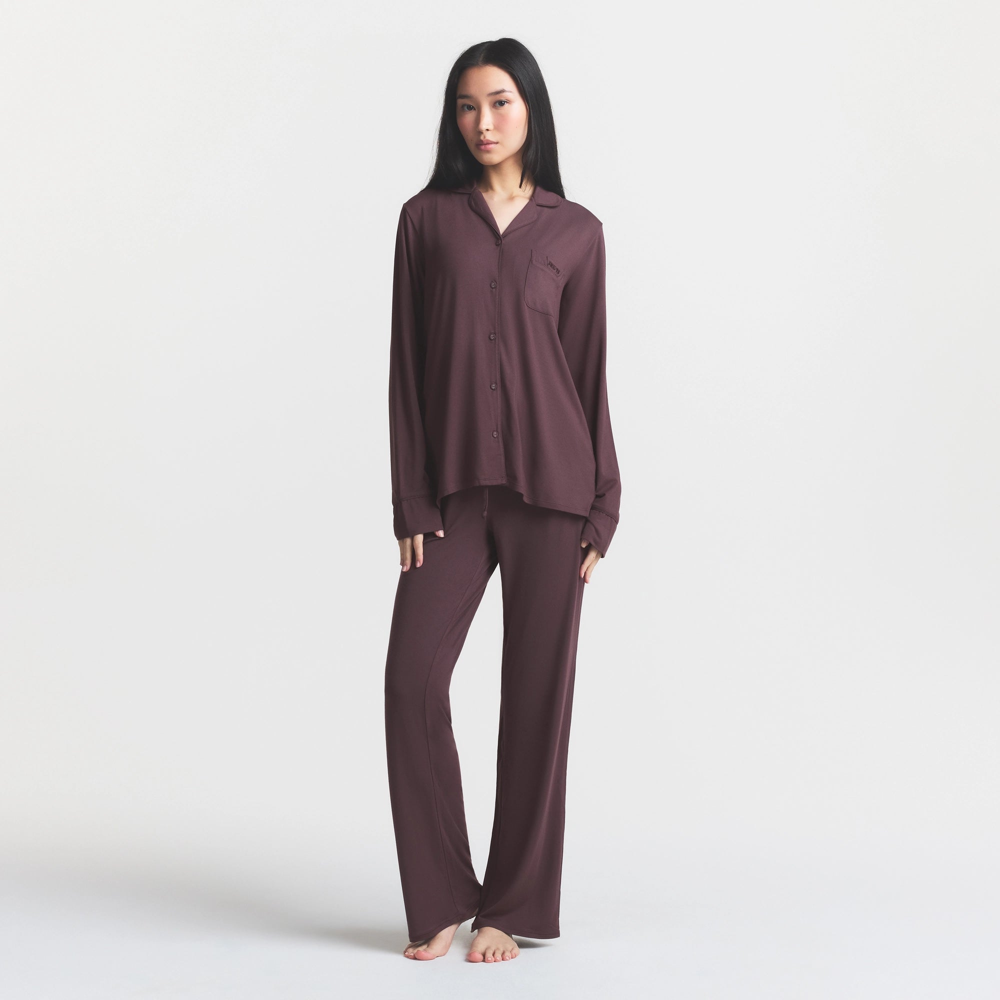 SKIMS SLEEP LONG SLEEVE BUTTON UP SET | RAISIN ON A MODEL FRONT VIEW @ | FOCUS: 0.0, 1.0, 0.9