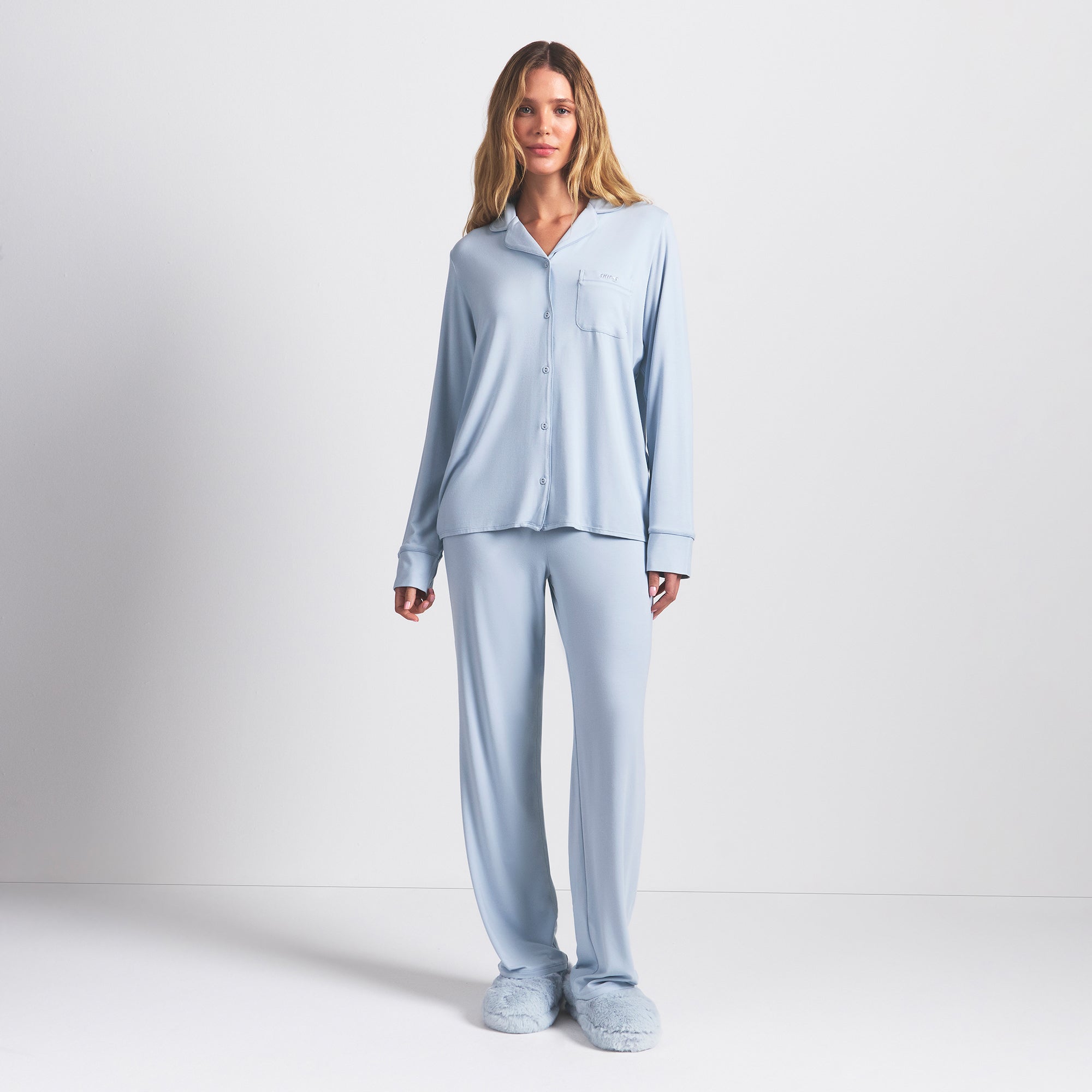 SKIMS SLEEP LONG SLEEVE BUTTON UP SET | ZEN BLUE ON A MODEL FRONT VIEW @ | FOCUS: 0.0, 1.0, 0.9