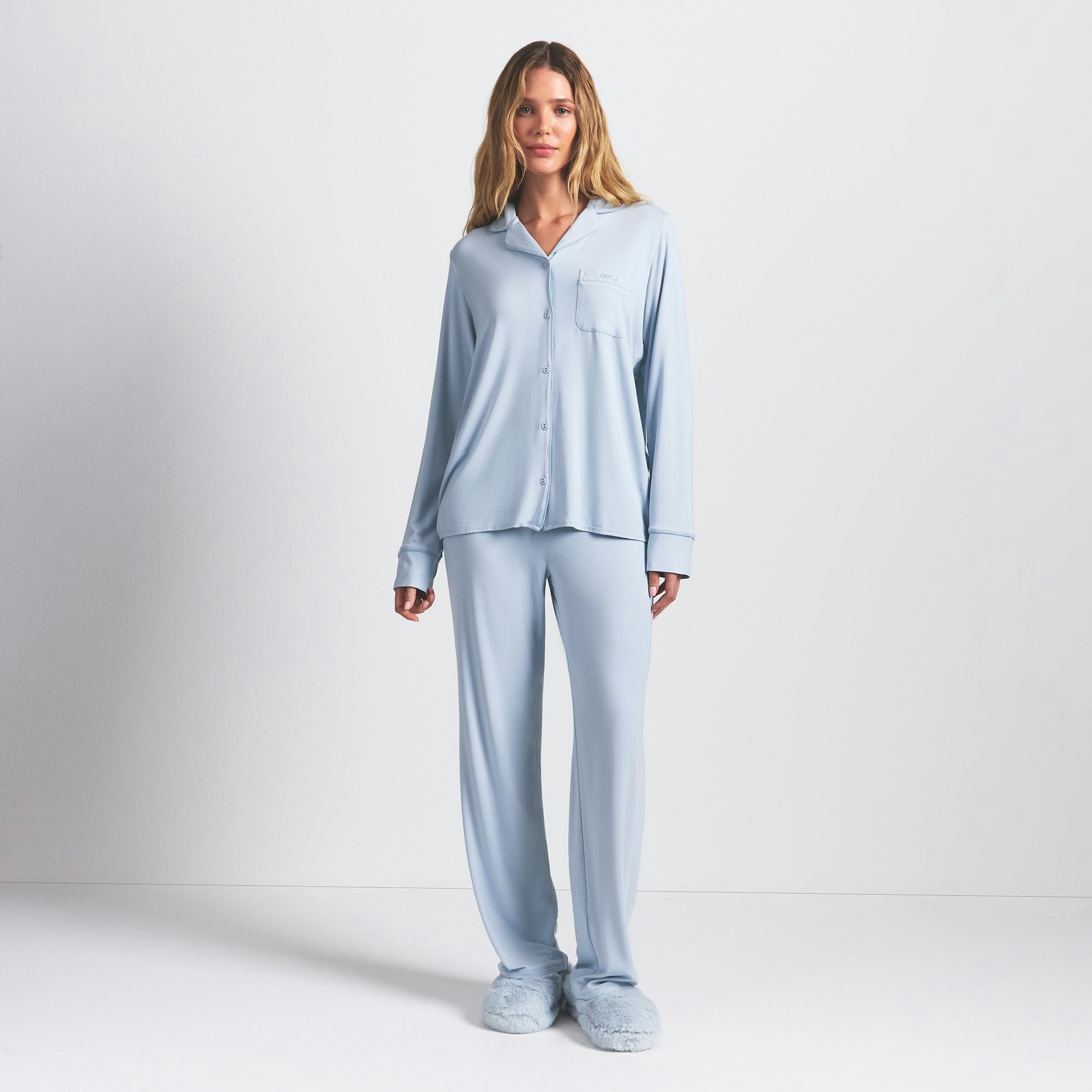 SKIMS SLEEP LONG SLEEVE BUTTON UP SET | ZEN BLUE ON A MODEL FRONT VIEW @ | FOCUS: 0.0, 1.0, 0.9
