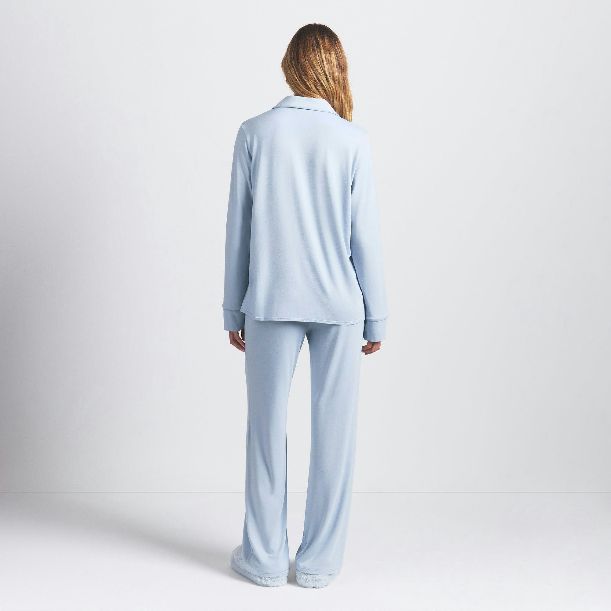 SKIMS SLEEP LONG SLEEVE BUTTON UP SET | ZEN BLUE ON A MODEL BACK VIEW @ | FOCUS: 0.0, 1.0, 0.9