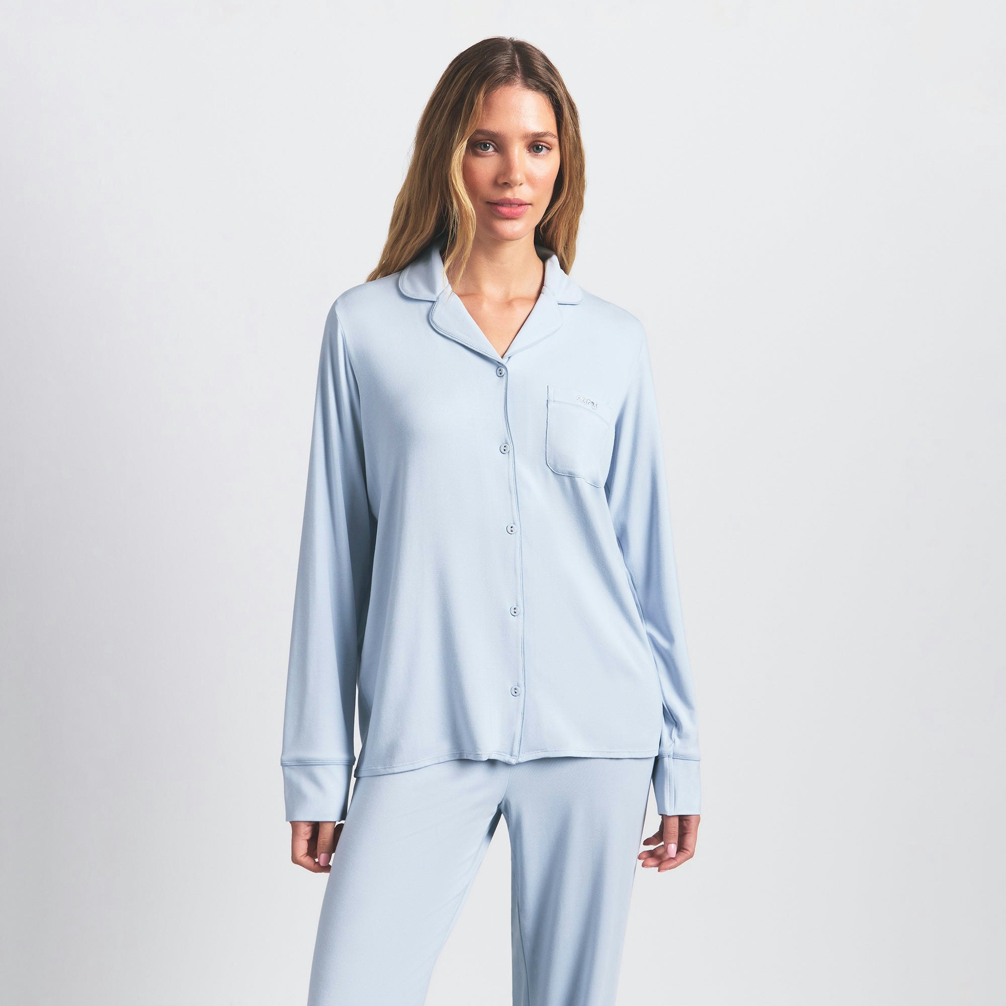 SKIMS SLEEP LONG SLEEVE BUTTON UP SET | ZEN BLUE ON A MODEL FRONT VIEW @ | FOCUS: 0.0, 1.0, 0.9
