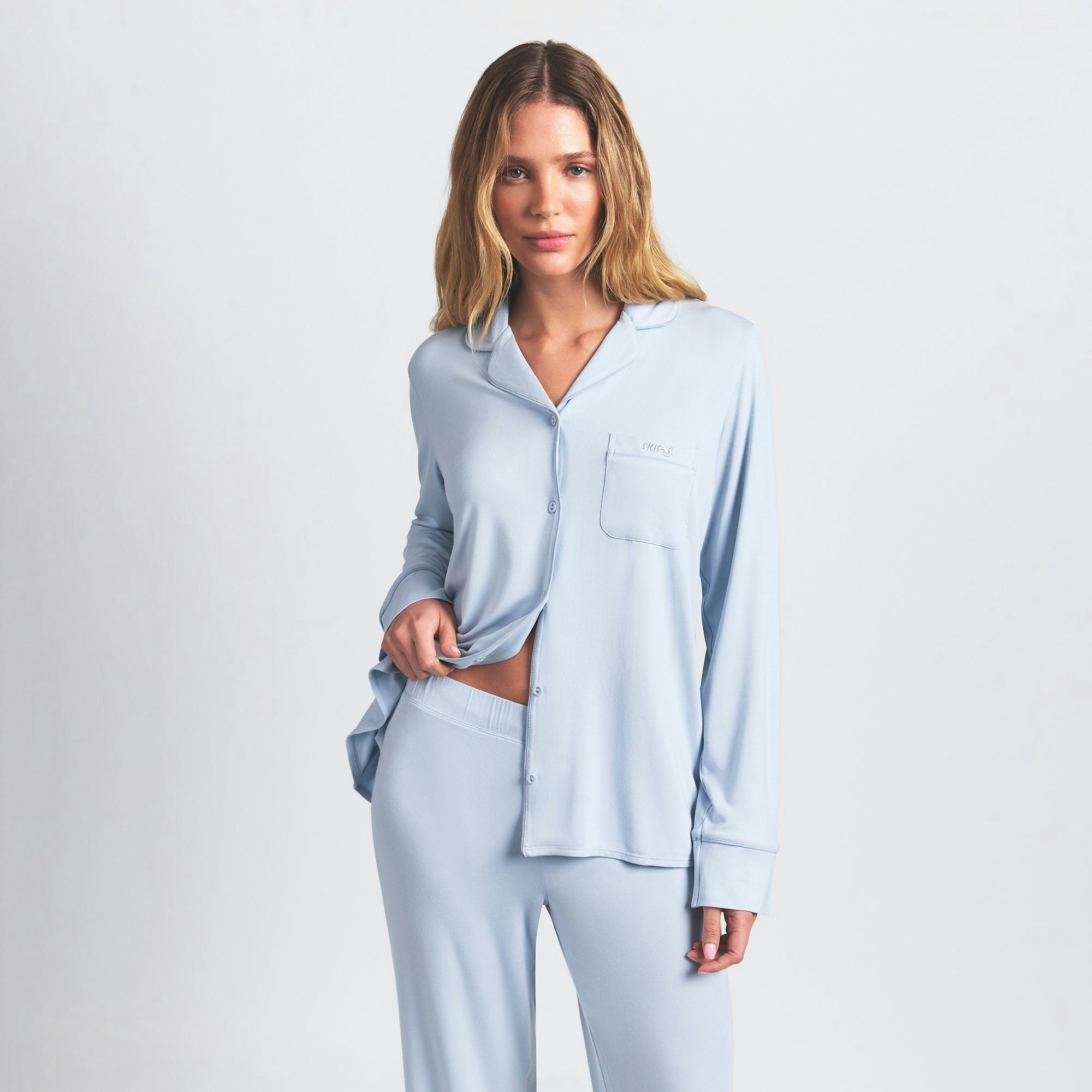 SKIMS SLEEP LONG SLEEVE BUTTON UP SET | ZEN BLUE ON A MODEL FRONT VIEW @ | FOCUS: 0.0, 1.0, 0.9