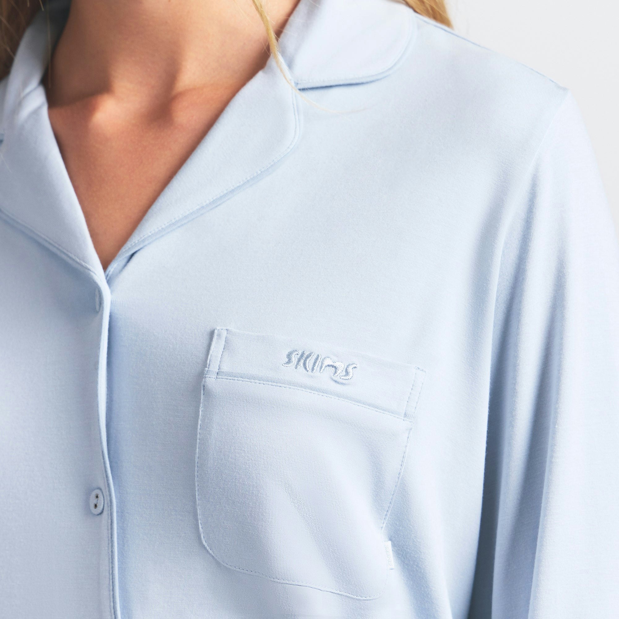 SKIMS SLEEP LONG SLEEVE BUTTON UP SET | ZEN BLUE ON A MODEL FRONT VIEW @ | FOCUS: 0.0, 1.0, 0.9