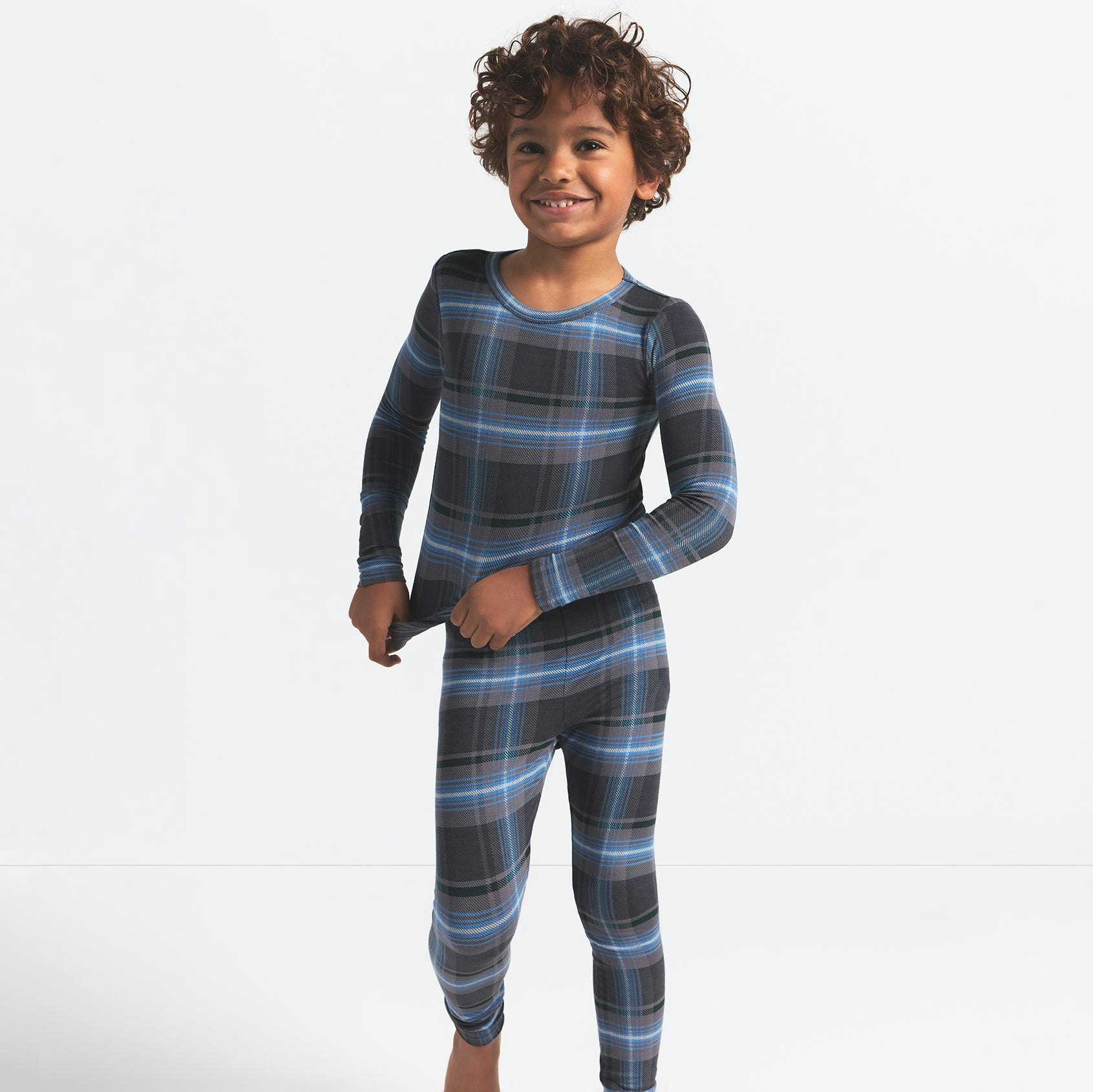 SKIMS SLEEP KIDS SLEEP SET | GLACIER PLAID ON A MODEL FRONT VIEW @ | FOCUS: 0.0, 1.0, 0.9