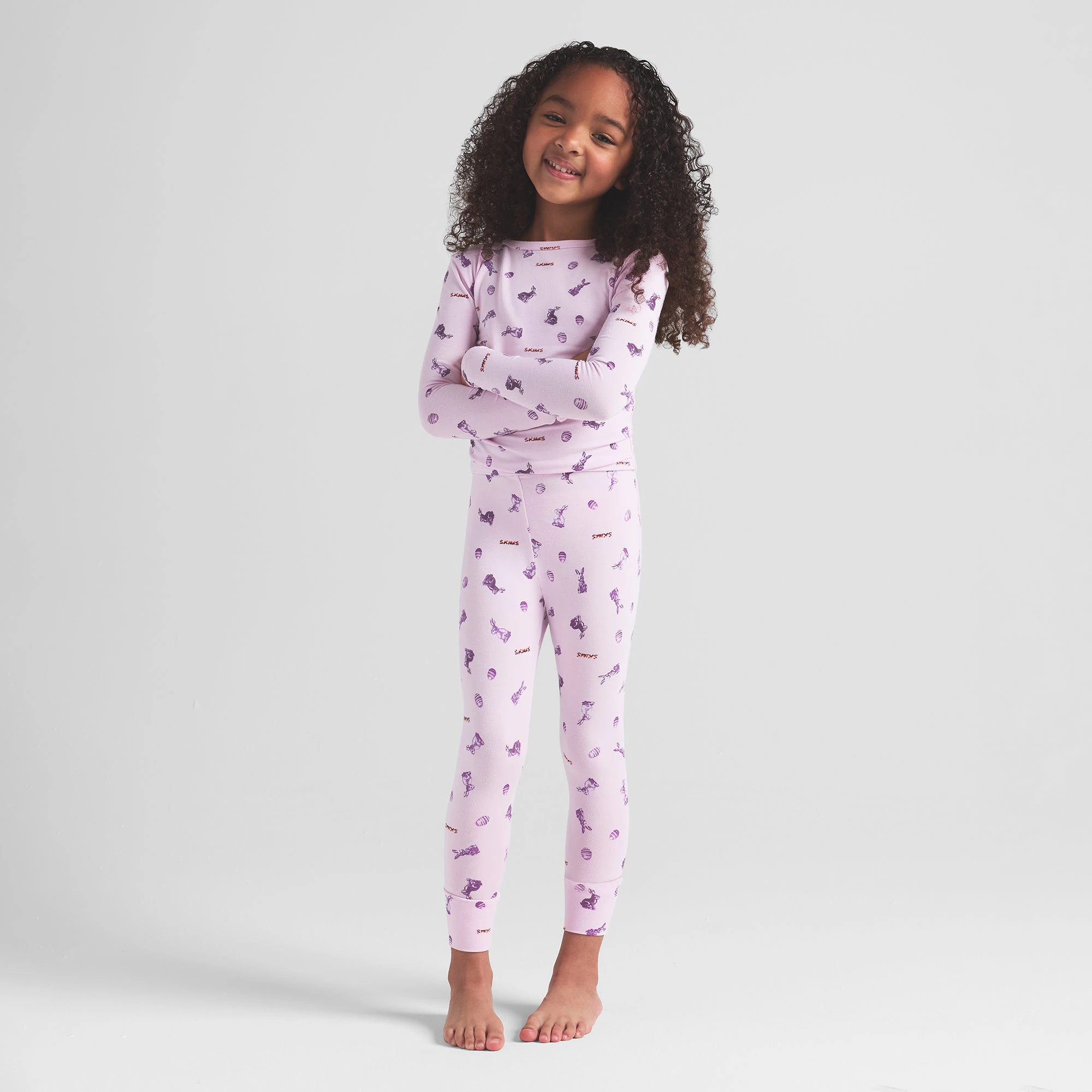 SKIMS SLEEP KIDS SLEEP SET | WILDROSE BUNNY PRINT ON A MODEL FRONT VIEW