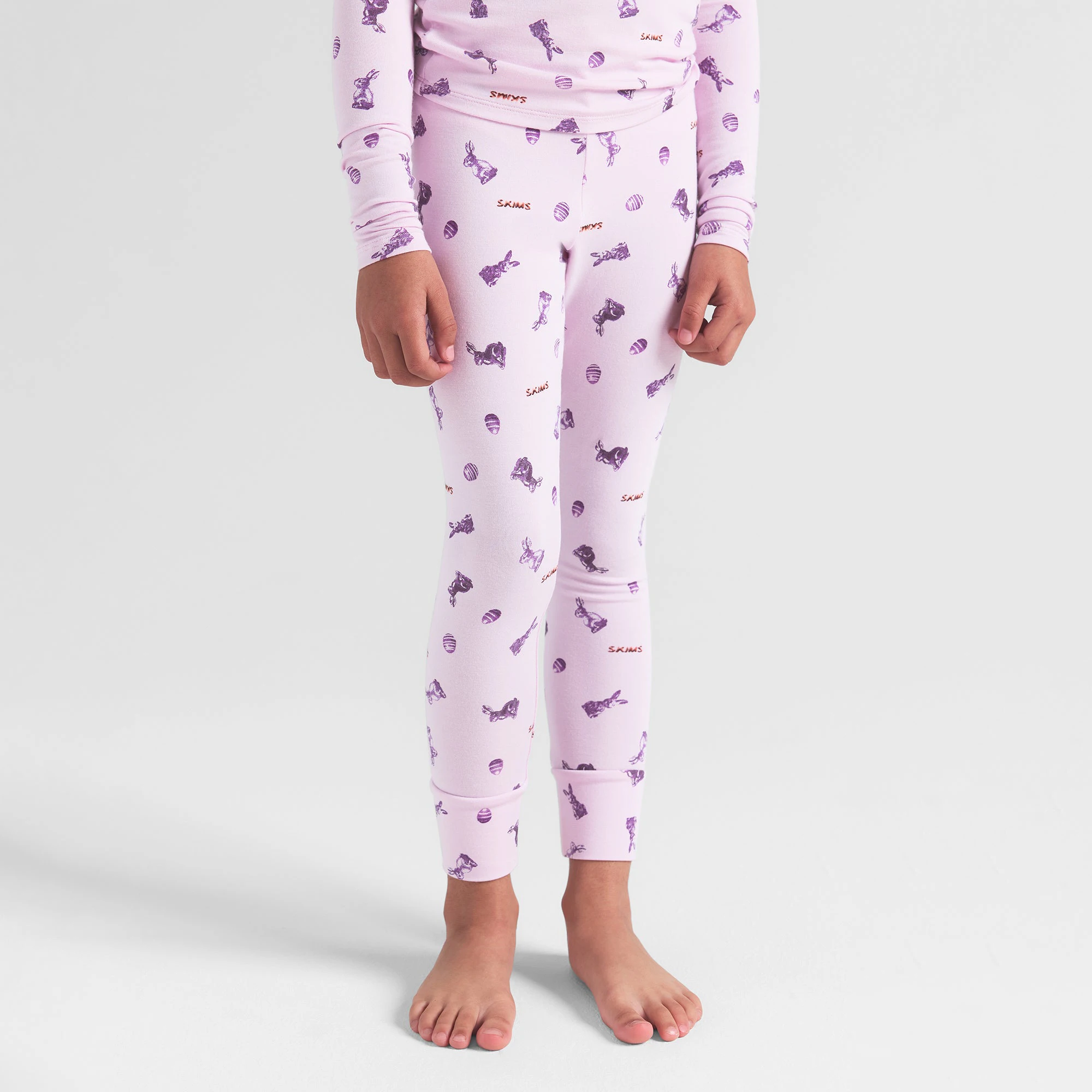 SKIMS SLEEP KIDS SLEEP SET | WILDROSE BUNNY PRINT ON A MODEL FRONT VIEW