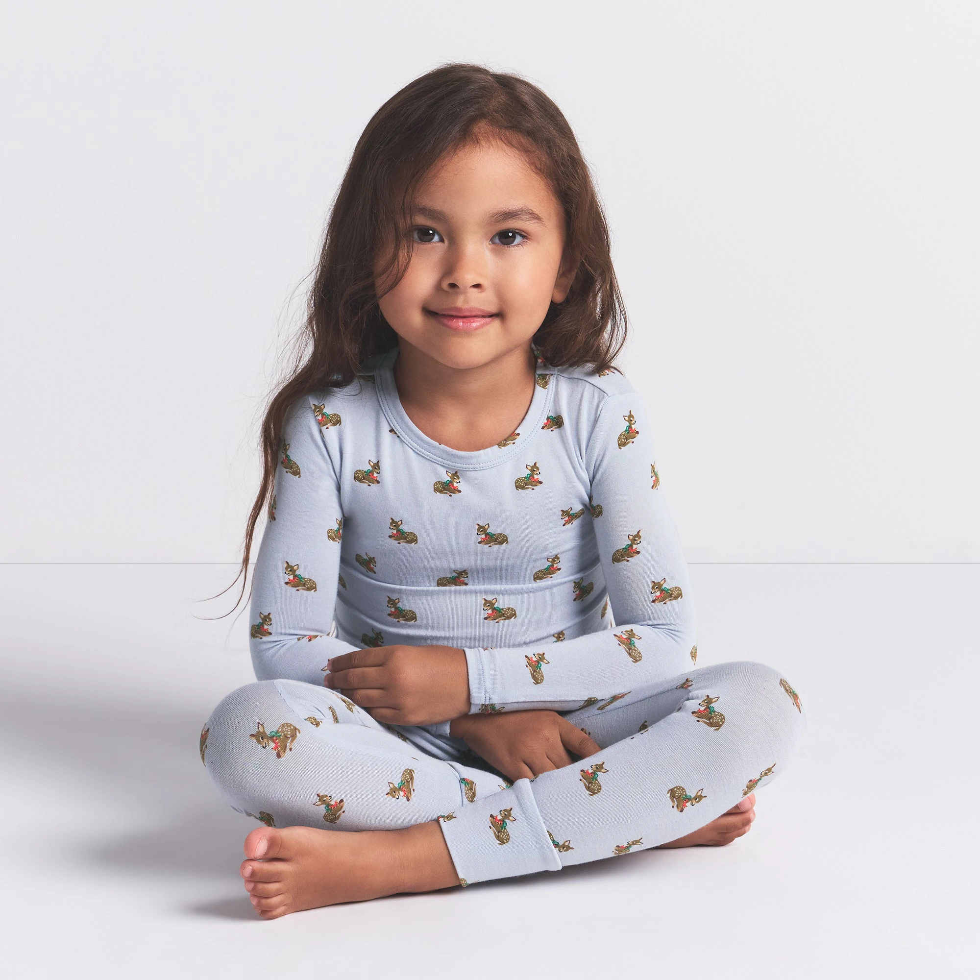 SKIMS SLEEP KIDS SLEEP SET | ZEN BLUE BABY DEER PRINT ON A MODEL FRONT VIEW @ | FOCUS: 0.0, 1.0, 0.9