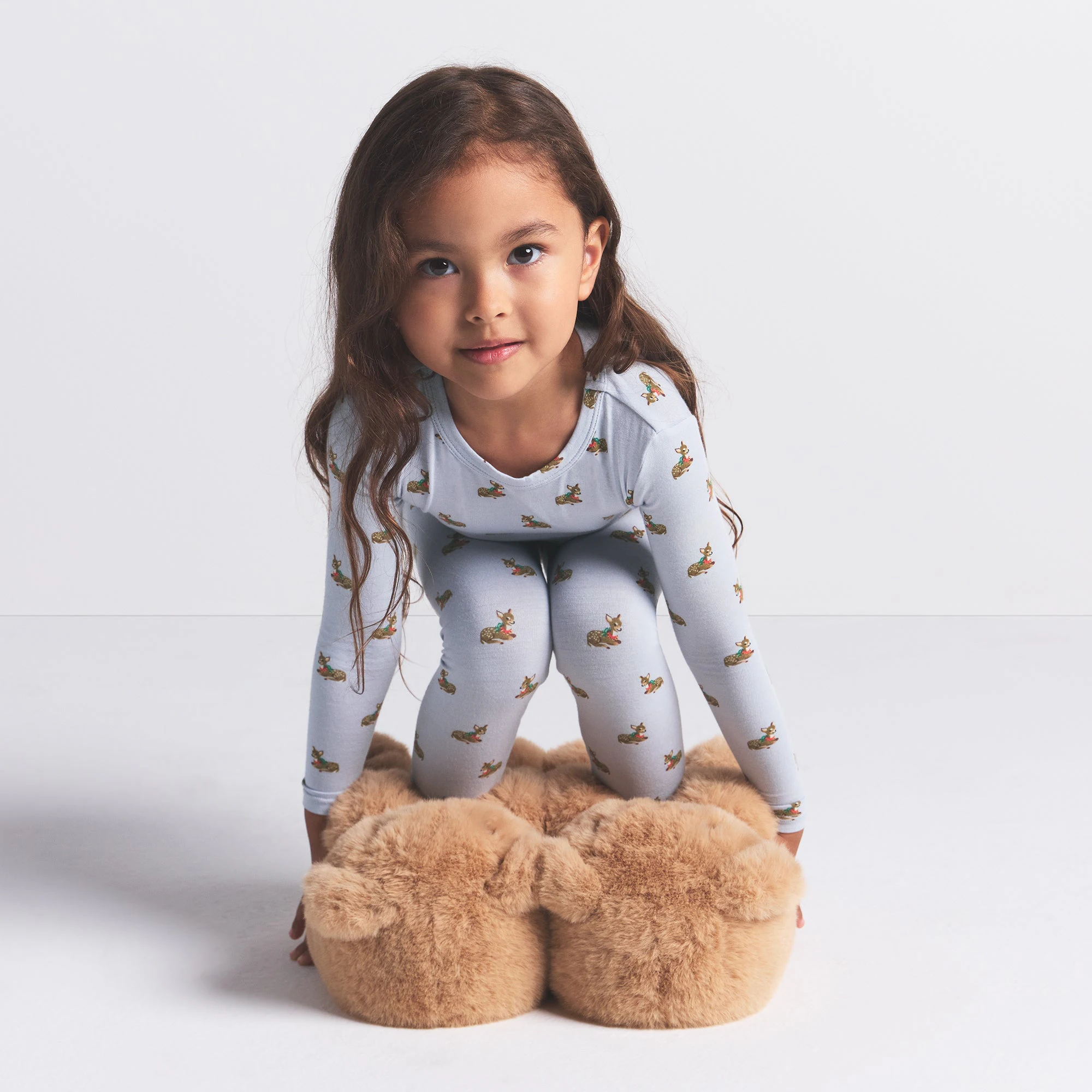 SKIMS SLEEP KIDS SLEEP SET | ZEN BLUE BABY DEER PRINT ON A MODEL FRONT VIEW @ | FOCUS: 0.0, 1.0, 0.9