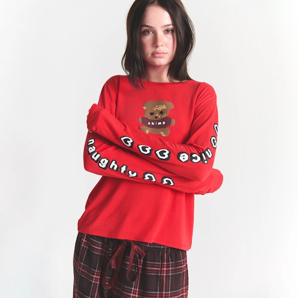 CACTUS PLANT FLEA MARKET X SKIMS SKIMS SLEEP FLANNEL PANT SET | RED BEAR PRINT ON A MODEL FRONT VIEW @ | FOCUS: 0.0, 1.0, 0.9