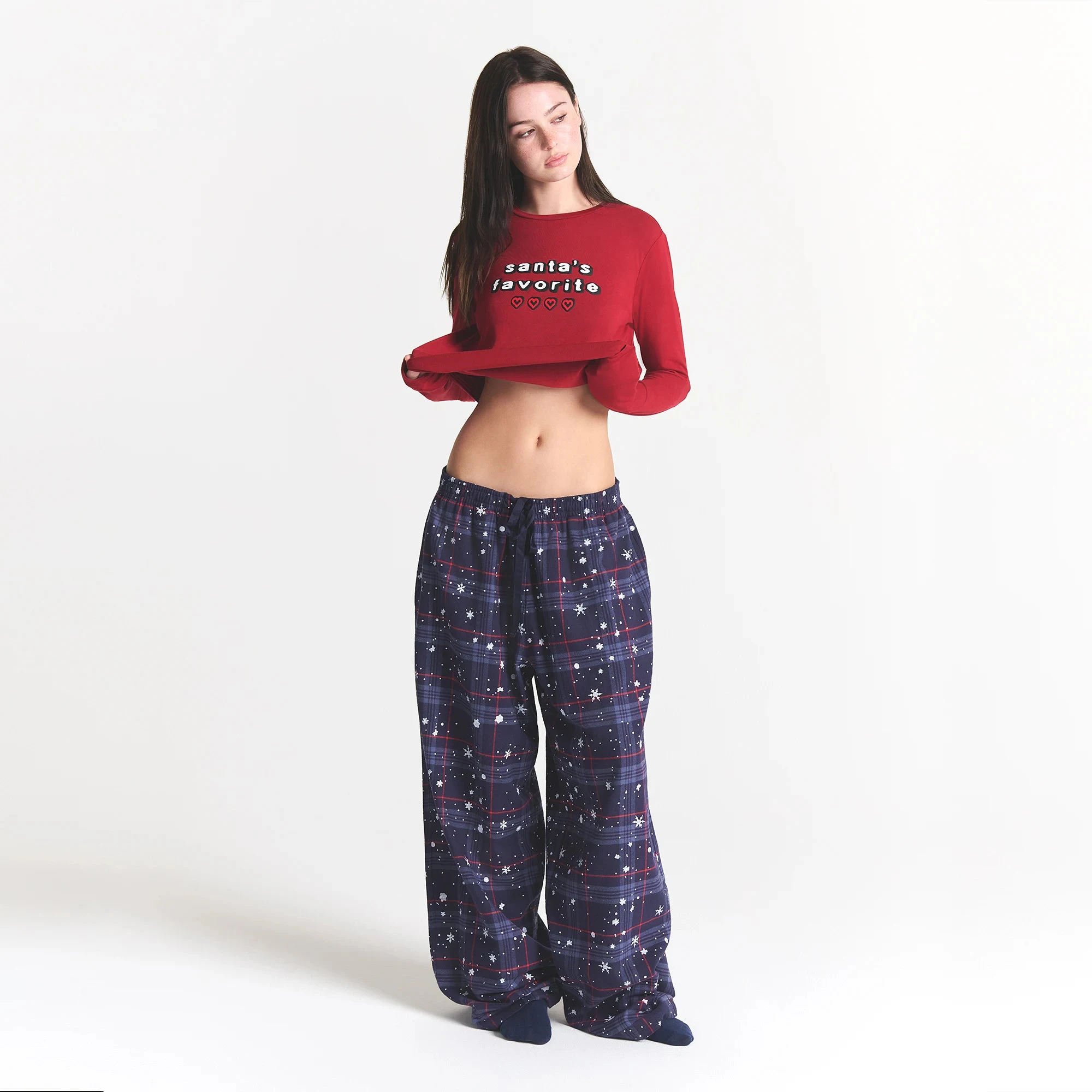 CACTUS PLANT FLEA MARKET X SKIMS SKIMS SLEEP FLANNEL PANT SET | SANTAS FAVORITE BRICK PRINT ON A MODEL FRONT VIEW @ | FOCUS: 0.0, 1.0, 0.9