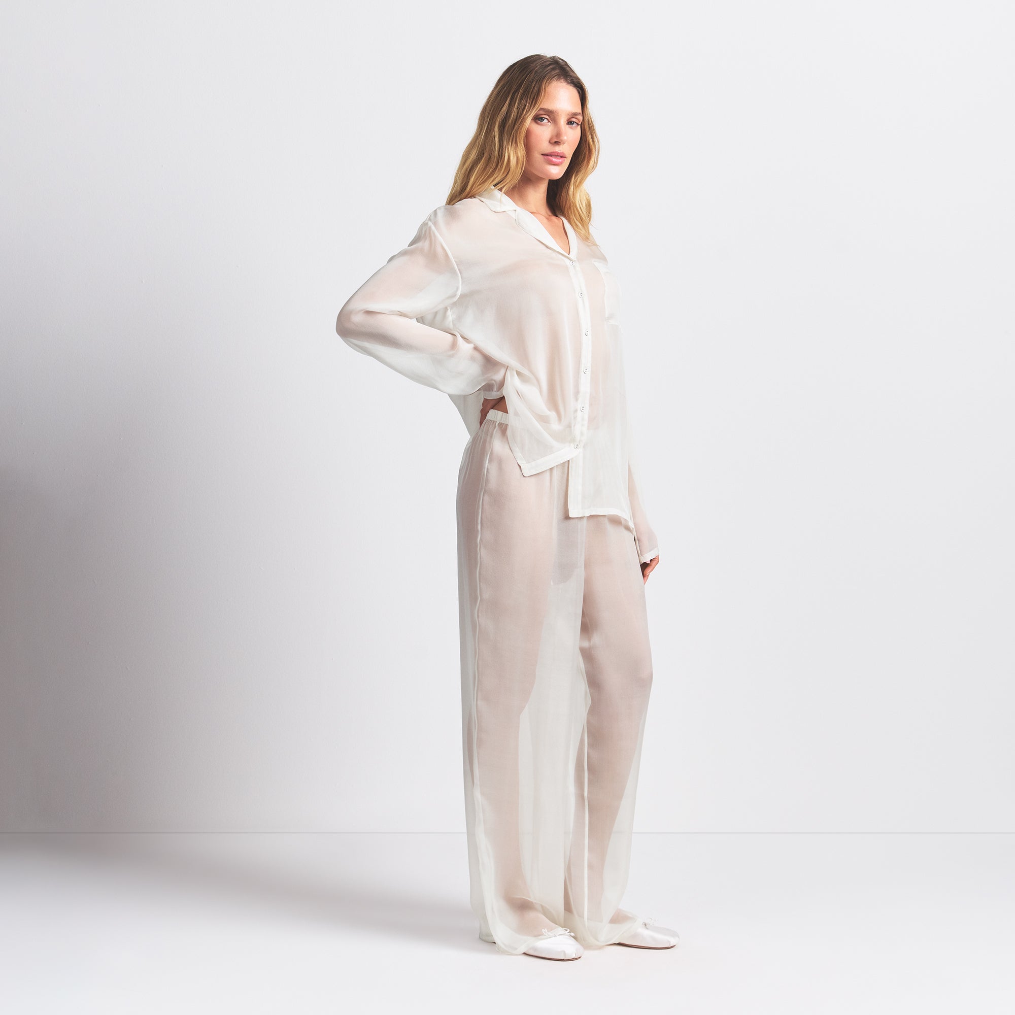 SKIMS ROMANCE BUTTON UP SHIRT AND PANT SET | ECRU ON A MODEL SIDE VIEW @ | FOCUS: 0.0, 1.0, 0.9