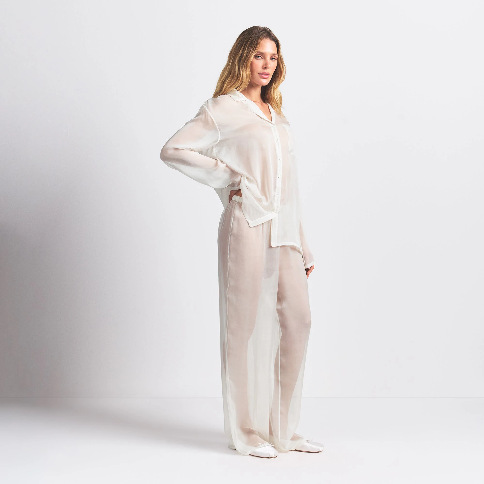 SKIMS ROMANCE BUTTON UP SHIRT AND PANT SET | ECRU ON A MODEL SIDE VIEW @ | FOCUS: 0.0, 1.0, 0.9