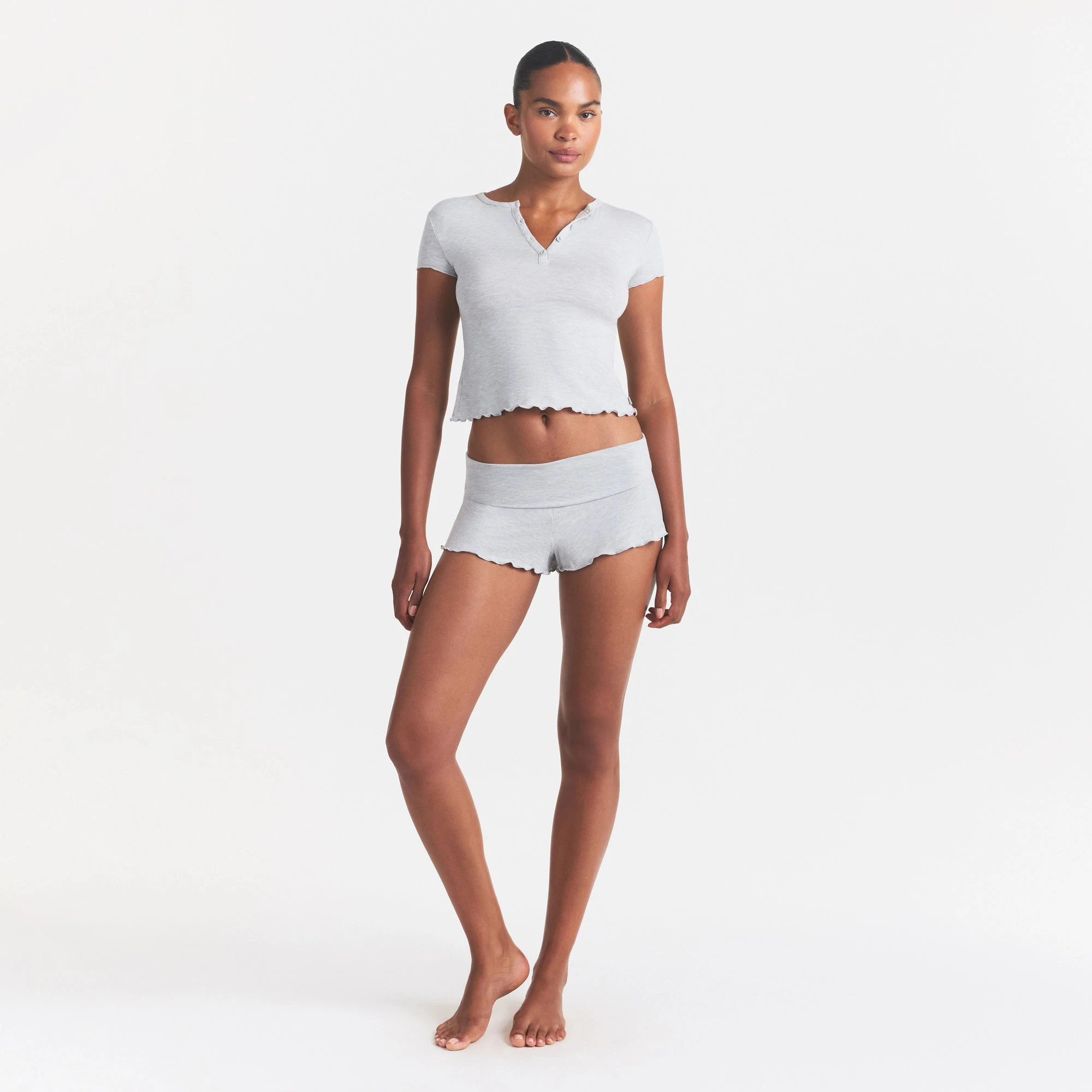 SKIMS SLEEP HENLEY AND FOLDOVER SHORT SET | LIGHT HEATHER GREY ON A MODEL FRONT VIEW @ | FOCUS: 0.0, 1.0, 0.9