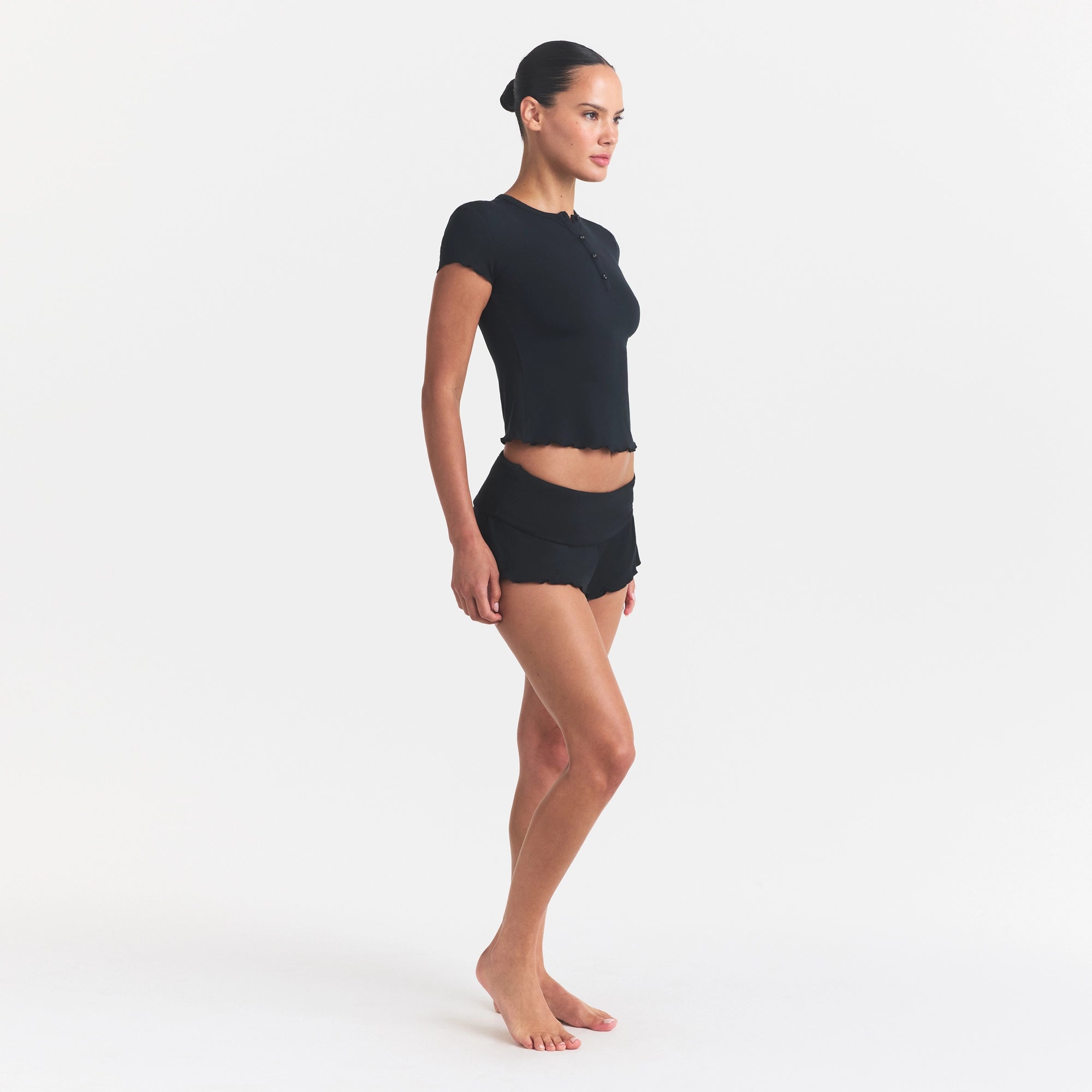 SKIMS SLEEP HENLEY AND FOLDOVER SHORT SET | ONYX ON A MODEL FRONT VIEW @ | FOCUS: 0.0, 1.0, 0.9