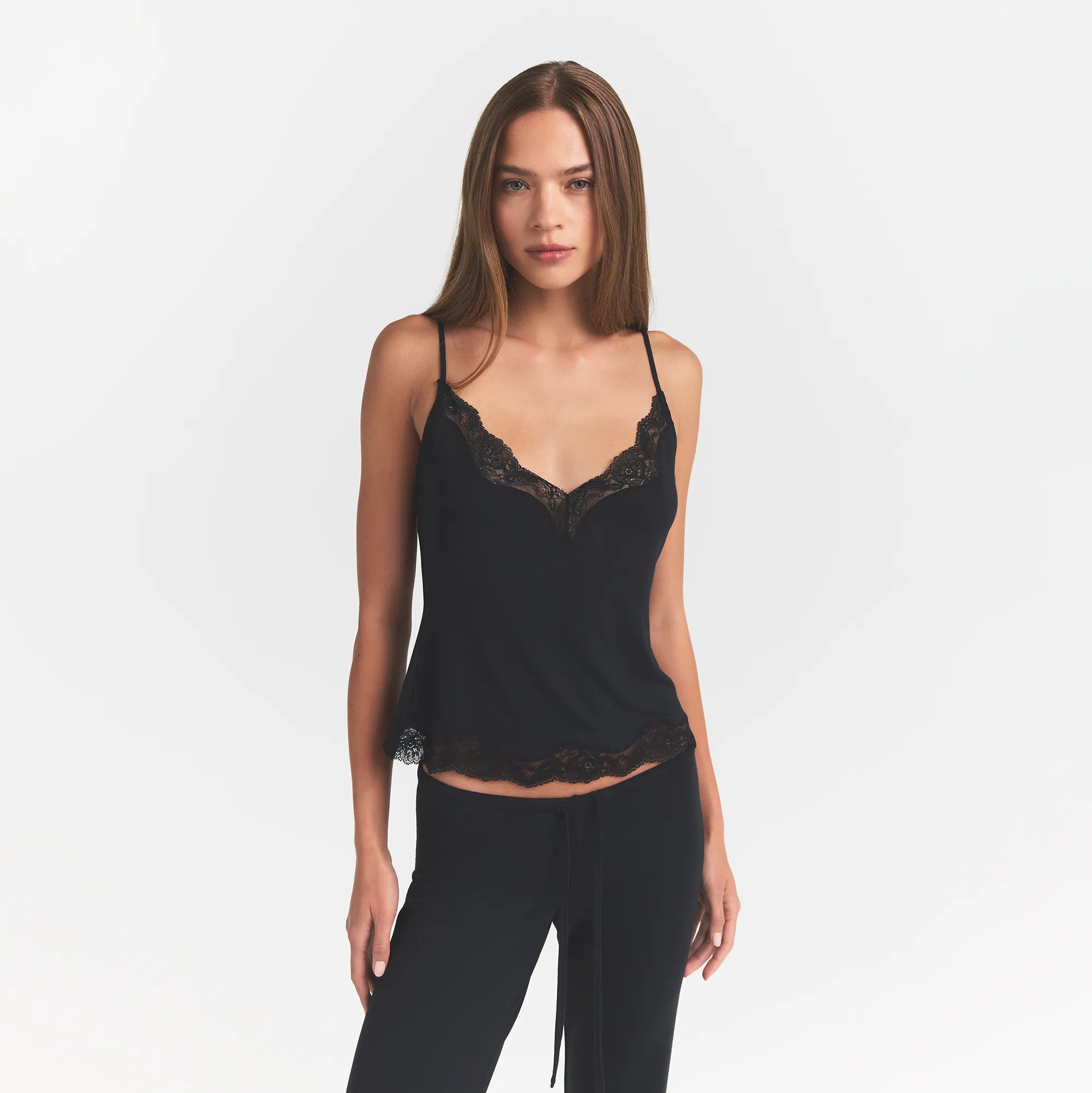 SKIMS SLEEP LACE CAMI AND PANT SET | ONYX ON A MODEL FRONT VIEW @ | FOCUS: 0.0, 1.0, 0.9