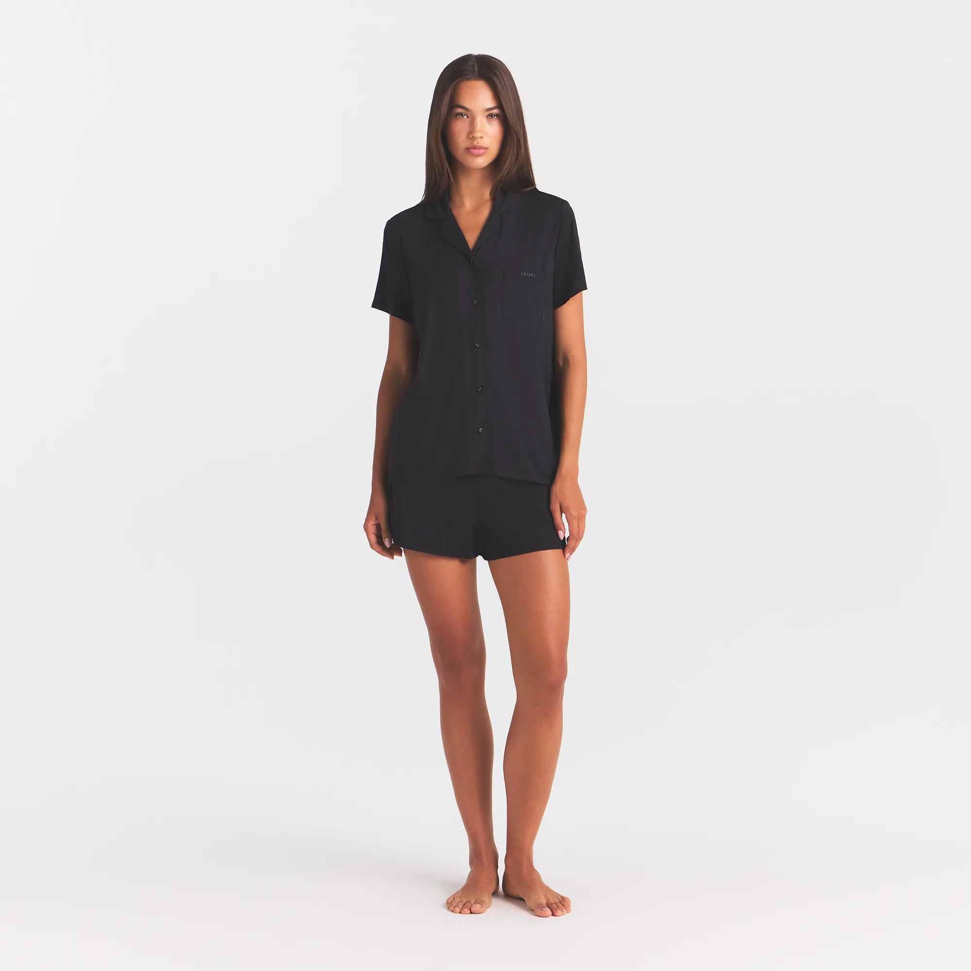 SKIMS SLEEP SHORT SLEEVE BUTTON UP SET | ONYX ON A MODEL FRONT VIEW