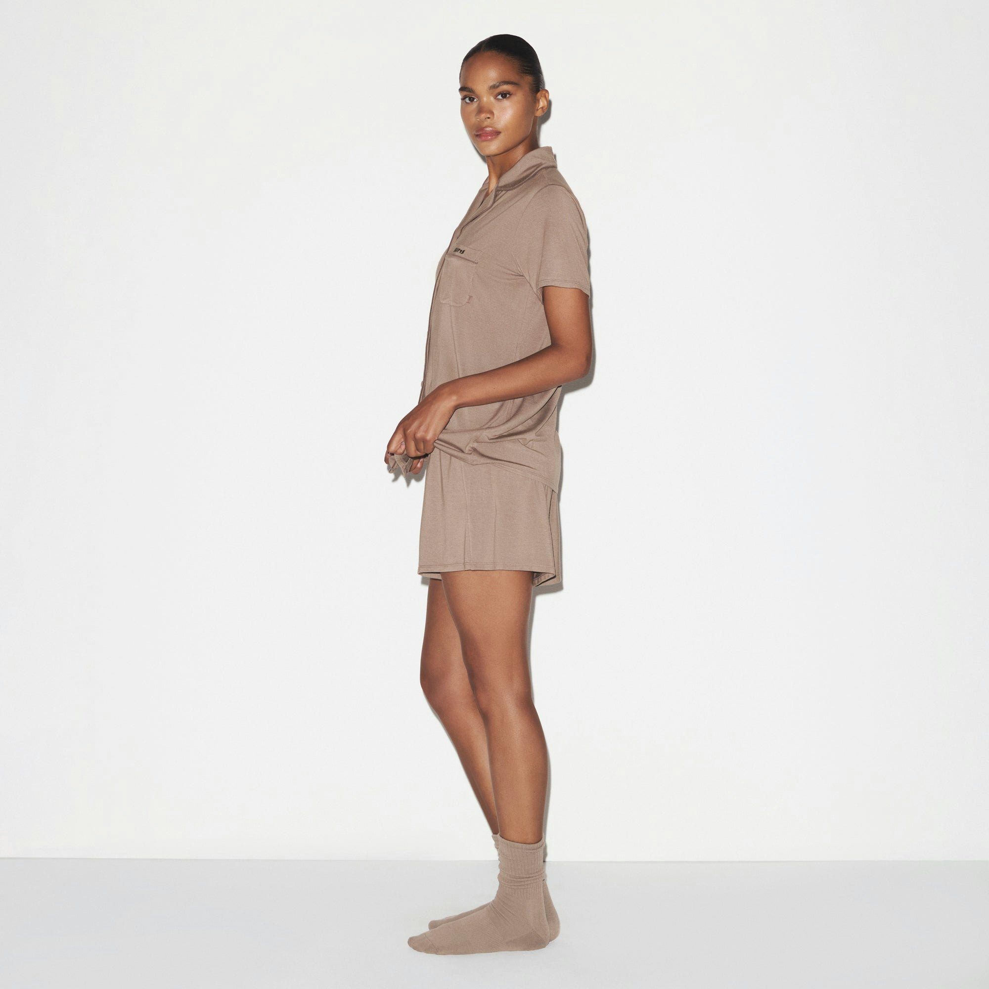 SKIMS SLEEP SHORT SLEEVE BUTTON UP SET | FOSSIL ON A MODEL SIDE VIEW @ | FOCUS: 0.0, 1.0, 0.9