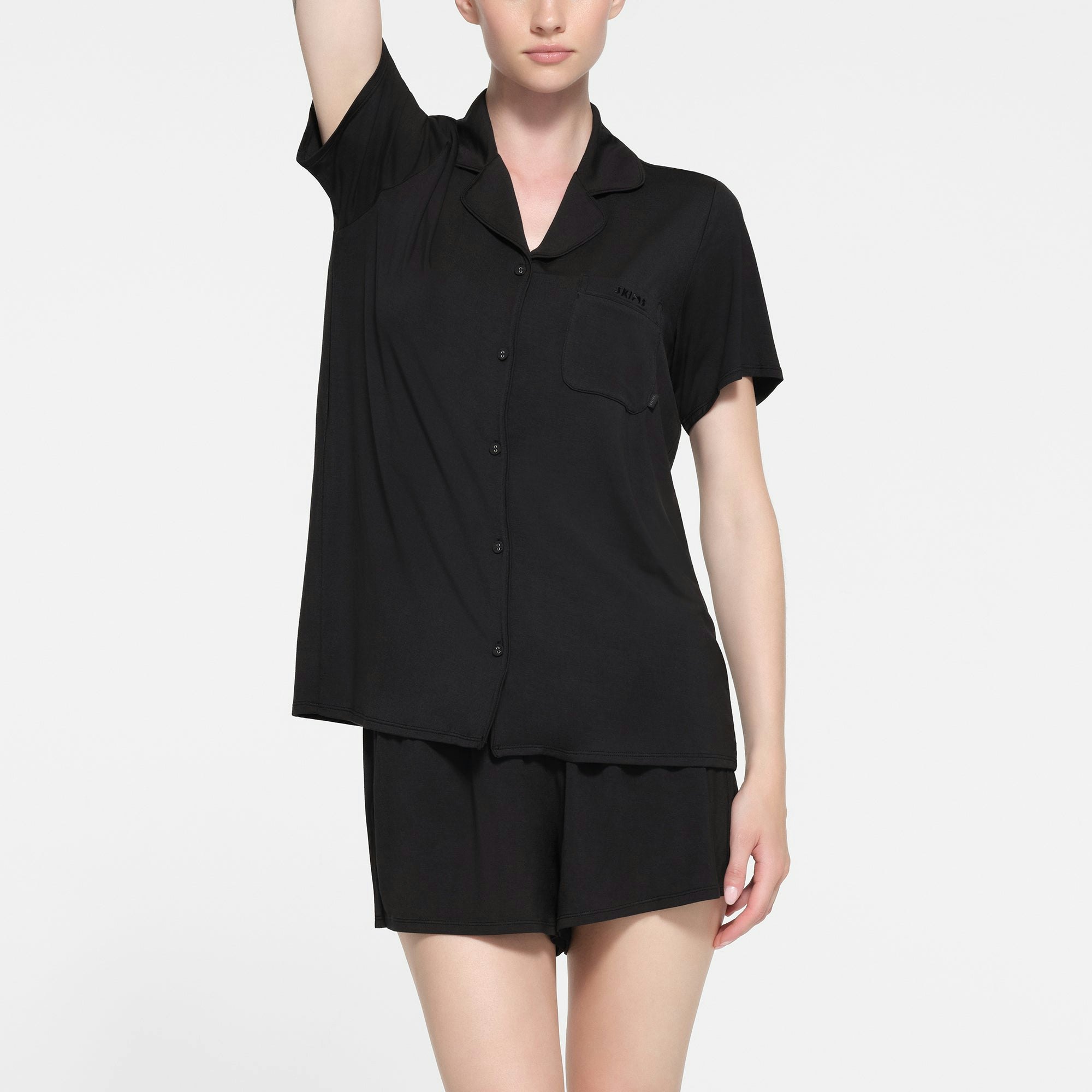 SKIMS SLEEP SHORT SLEEVE BUTTON UP SET | ONYX ON A MODEL FRONT VIEW