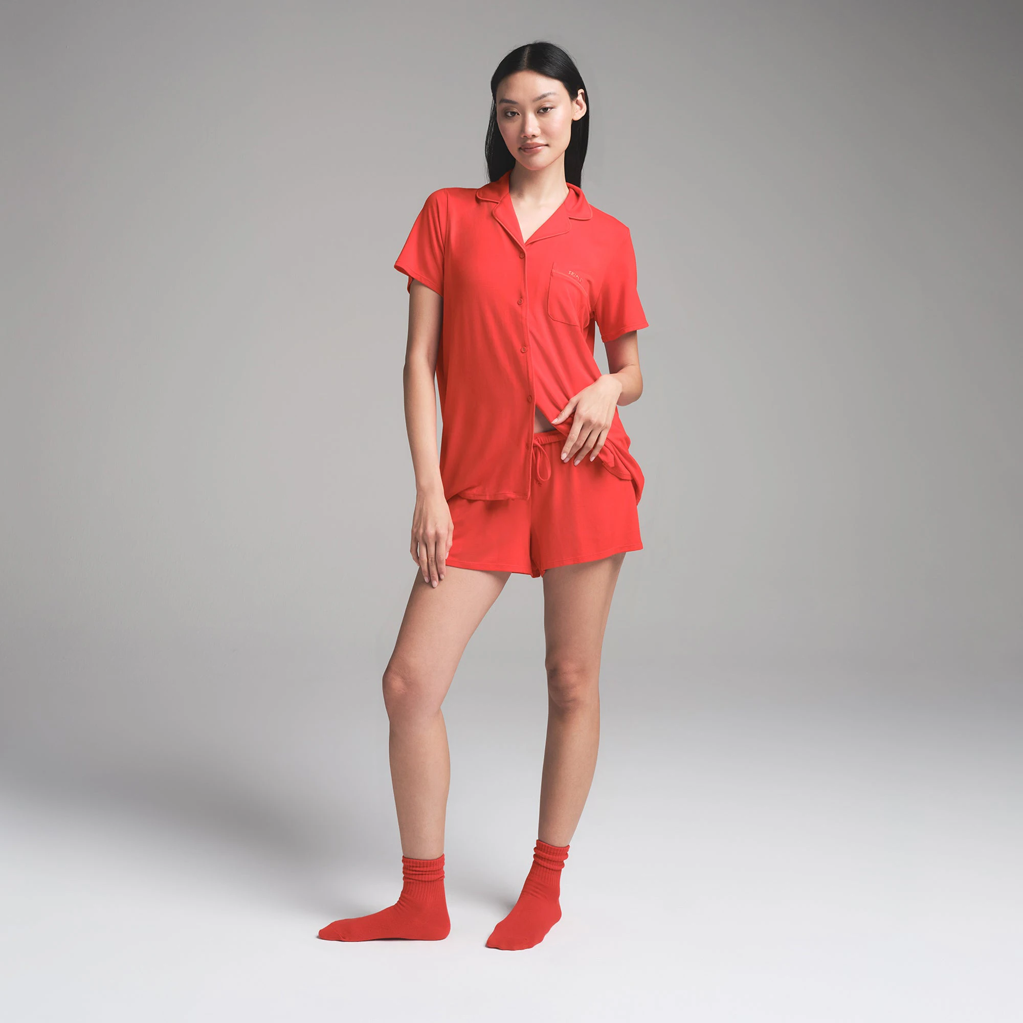 SKIMS SLEEP SHORT SLEEVE BUTTON UP SET | RUBY ON A MODEL FRONT VIEW | FOCUS: 0.0, 1.0, 0.9