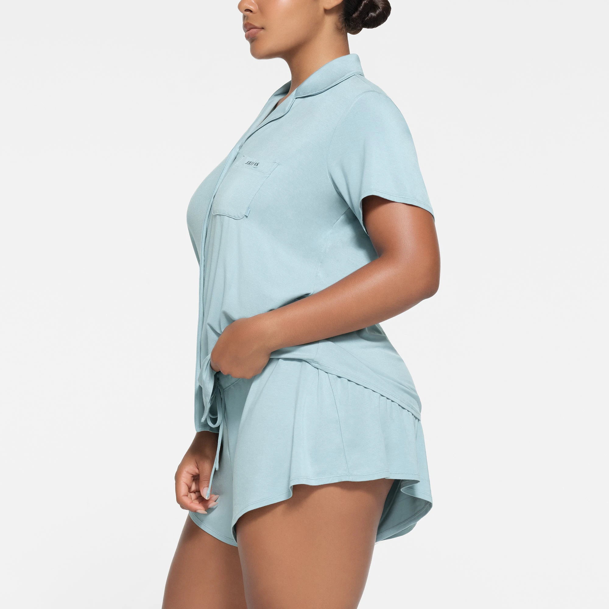 SKIMS SLEEP SHORT SLEEVE BUTTON UP SET | SKY ON A MODEL SIDE VIEW