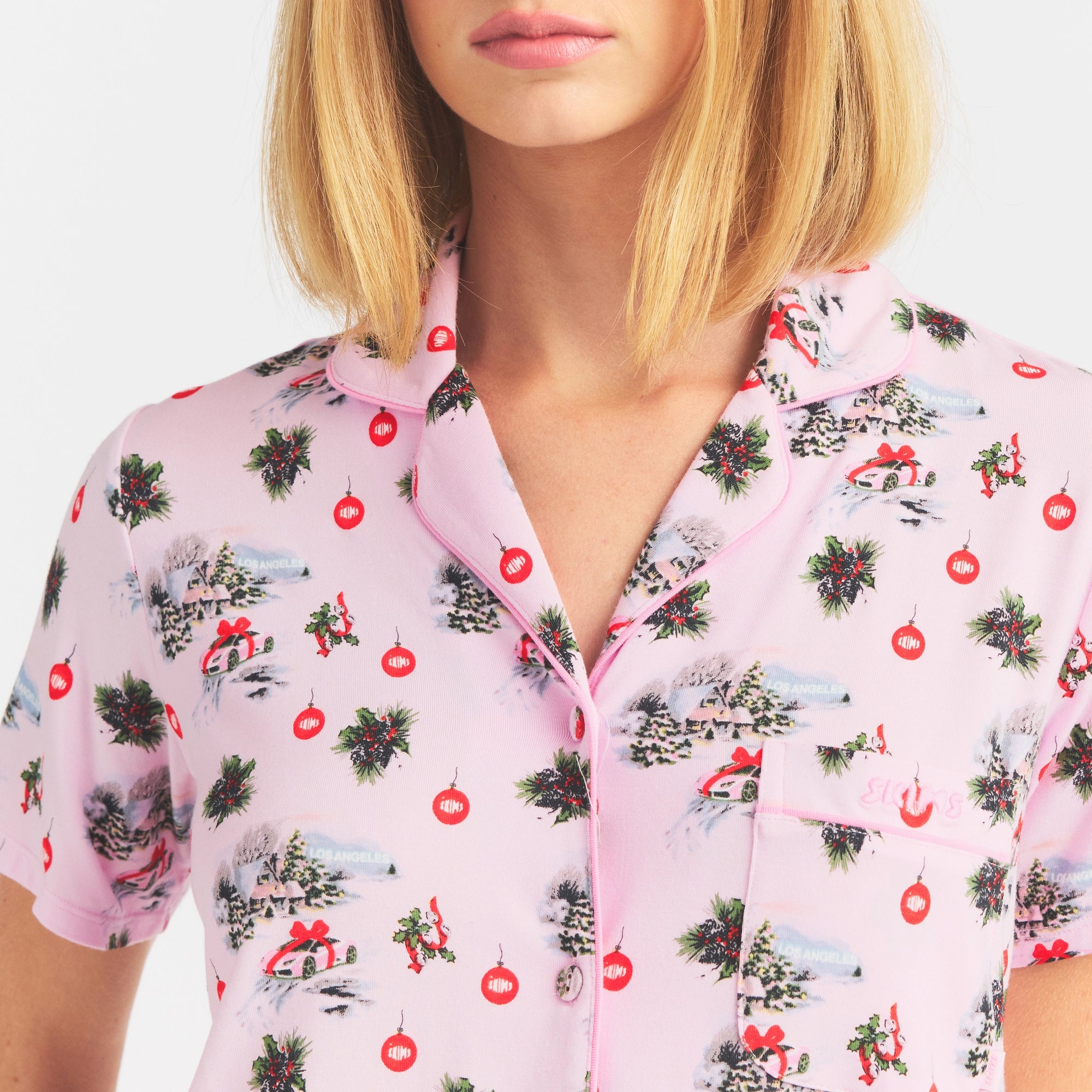 SKIMS SLEEP SHORT SLEEVE BUTTON UP SET | CHERRY BLOSSOM SPORTS CAR GIFT ON A MODEL SIDE VIEW @ | FOCUS: 0.0, 1.0, 0.9