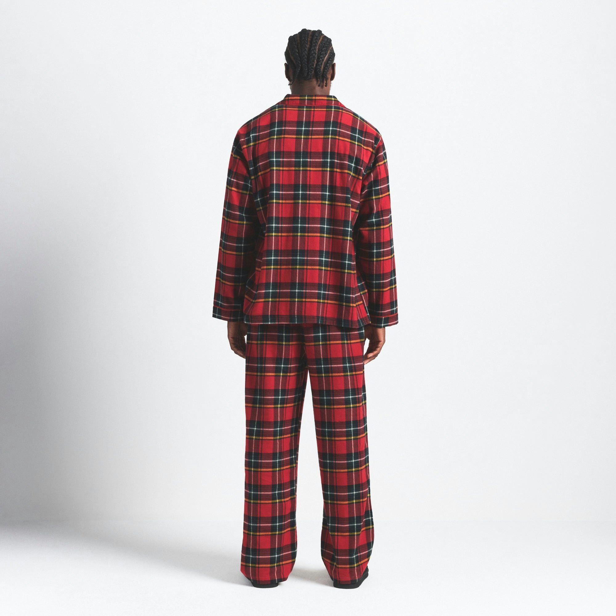 FLANNEL SLEEP MENS SLEEP SET | RED HOLIDAY PLAID ON A MODEL SIDE VIEW @ | FOCUS: 0.0, 1.0, 0.9