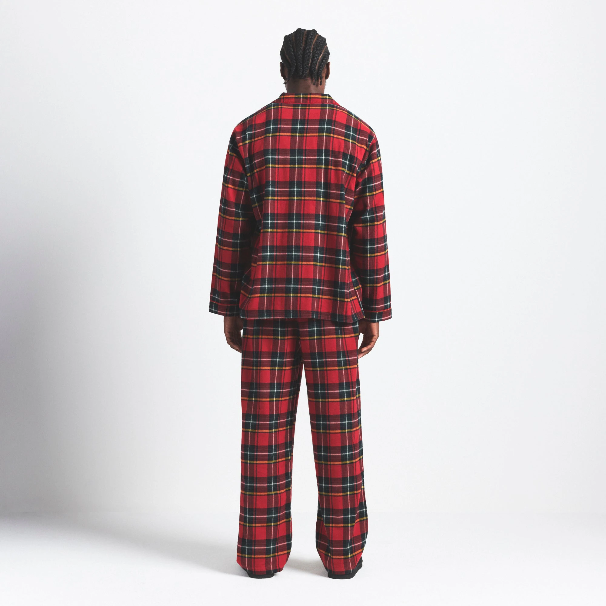 FLANNEL SLEEP MENS SLEEP SET | RED HOLIDAY PLAID ON A MODEL SIDE VIEW @ | FOCUS: 0.0, 1.0, 0.9