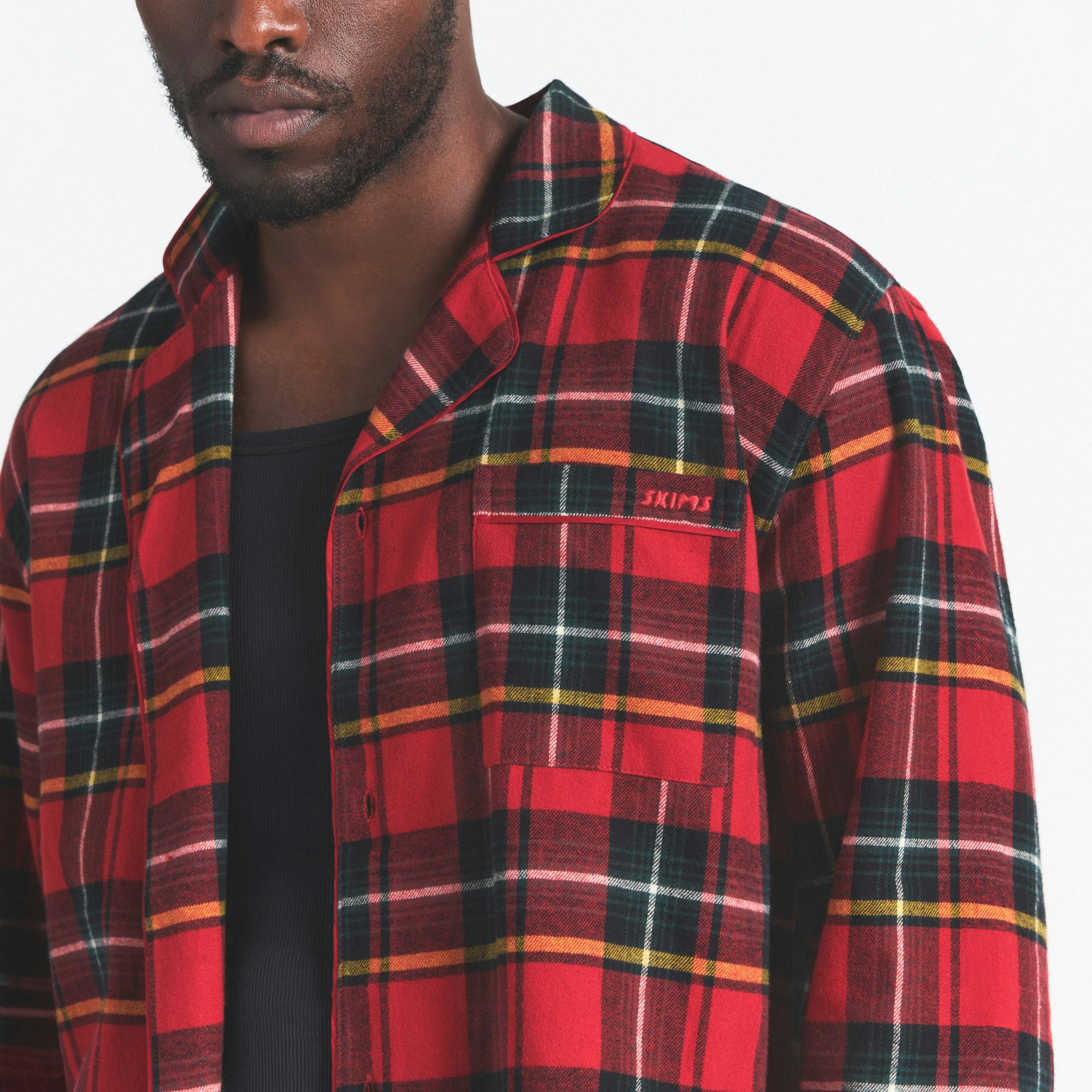 FLANNEL SLEEP MENS SLEEP SET | RED HOLIDAY PLAID ON A MODEL SIDE VIEW @ | FOCUS: 0.0, 1.0, 0.9