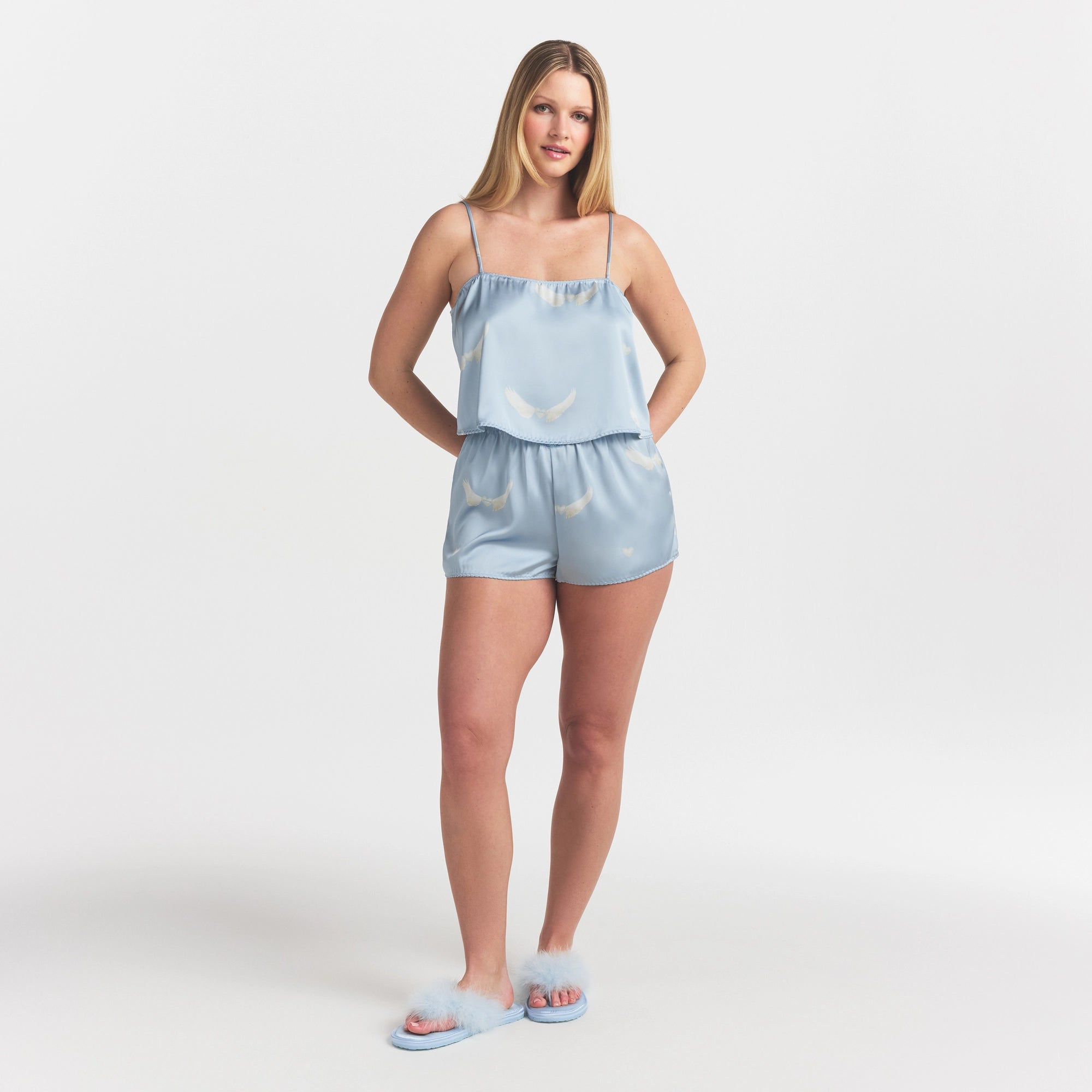 WOVEN SHINE CAMI AND SHORT SLEEP SET | AERO WING HEARTS PRINT ON A MODEL FRONT VIEW @ | FOCUS: 0.0, 1.0, 0.9