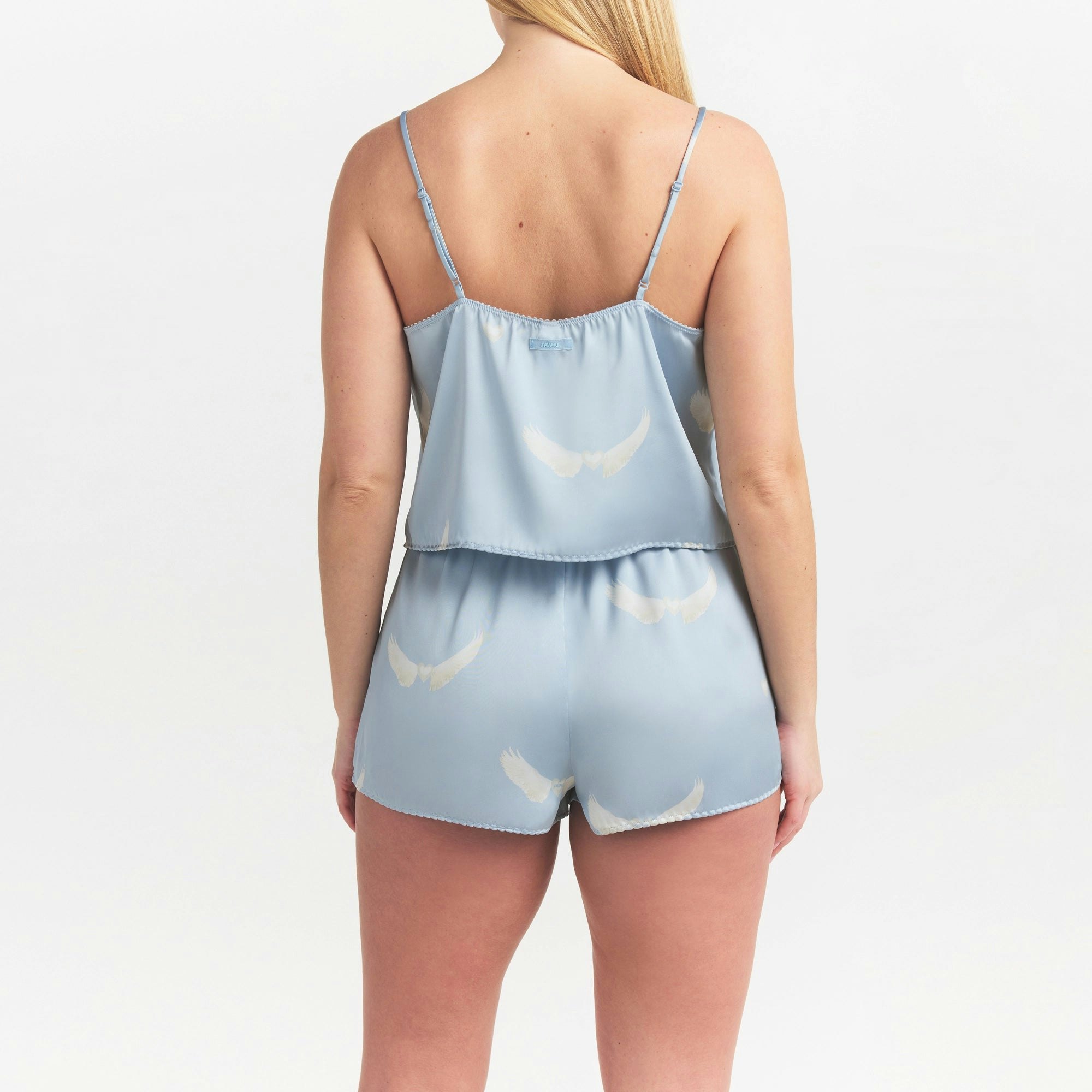 WOVEN SHINE CAMI AND SHORT SLEEP SET | AERO WING HEARTS PRINT ON A MODEL SIDE VIEW @ | FOCUS: 0.0, 1.0, 0.9