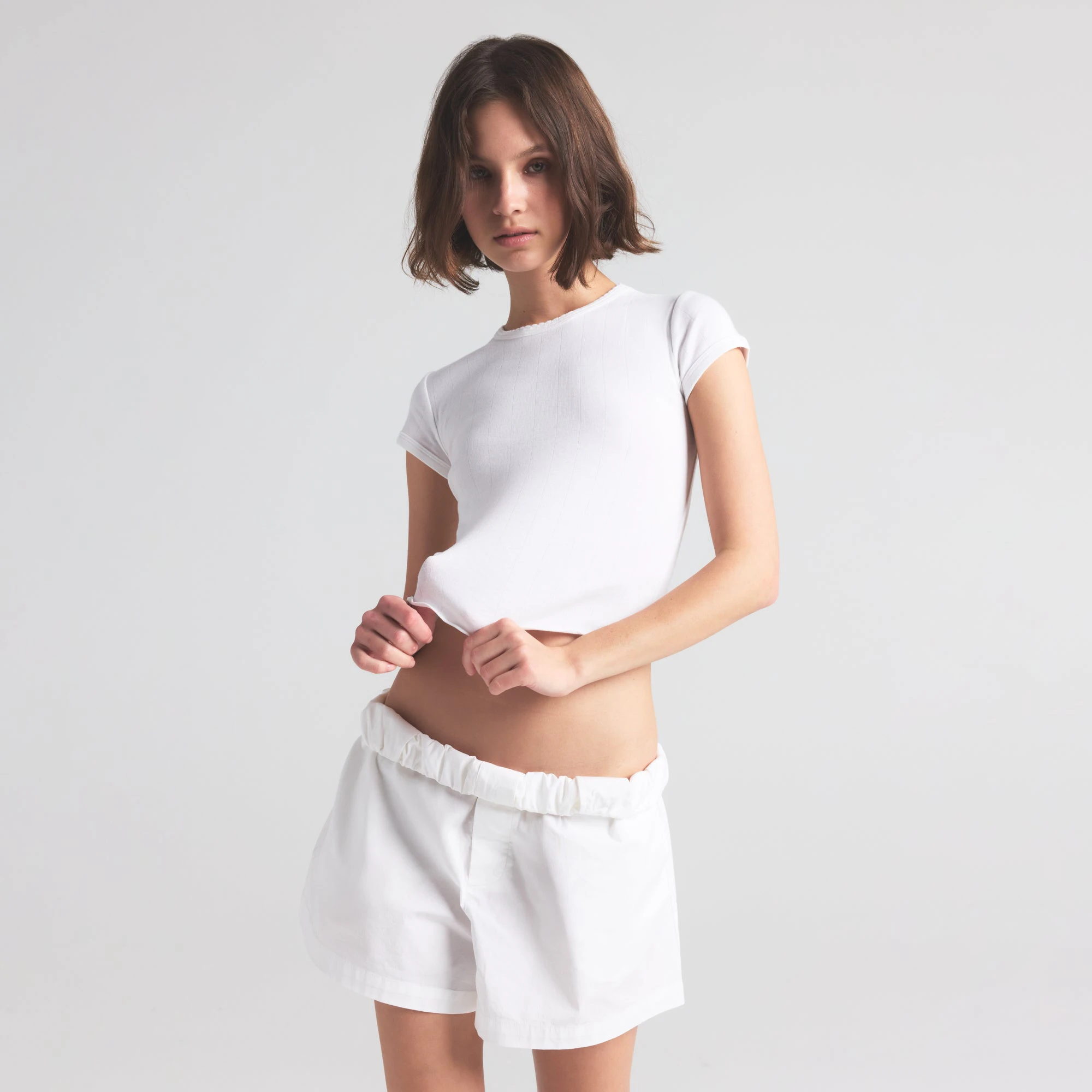 DROP NEEDLE POINTELLE BABY TEE | SNOW ON A MODEL FRONT VIEW | FOCUS: 0.0, 1.0, 0.9