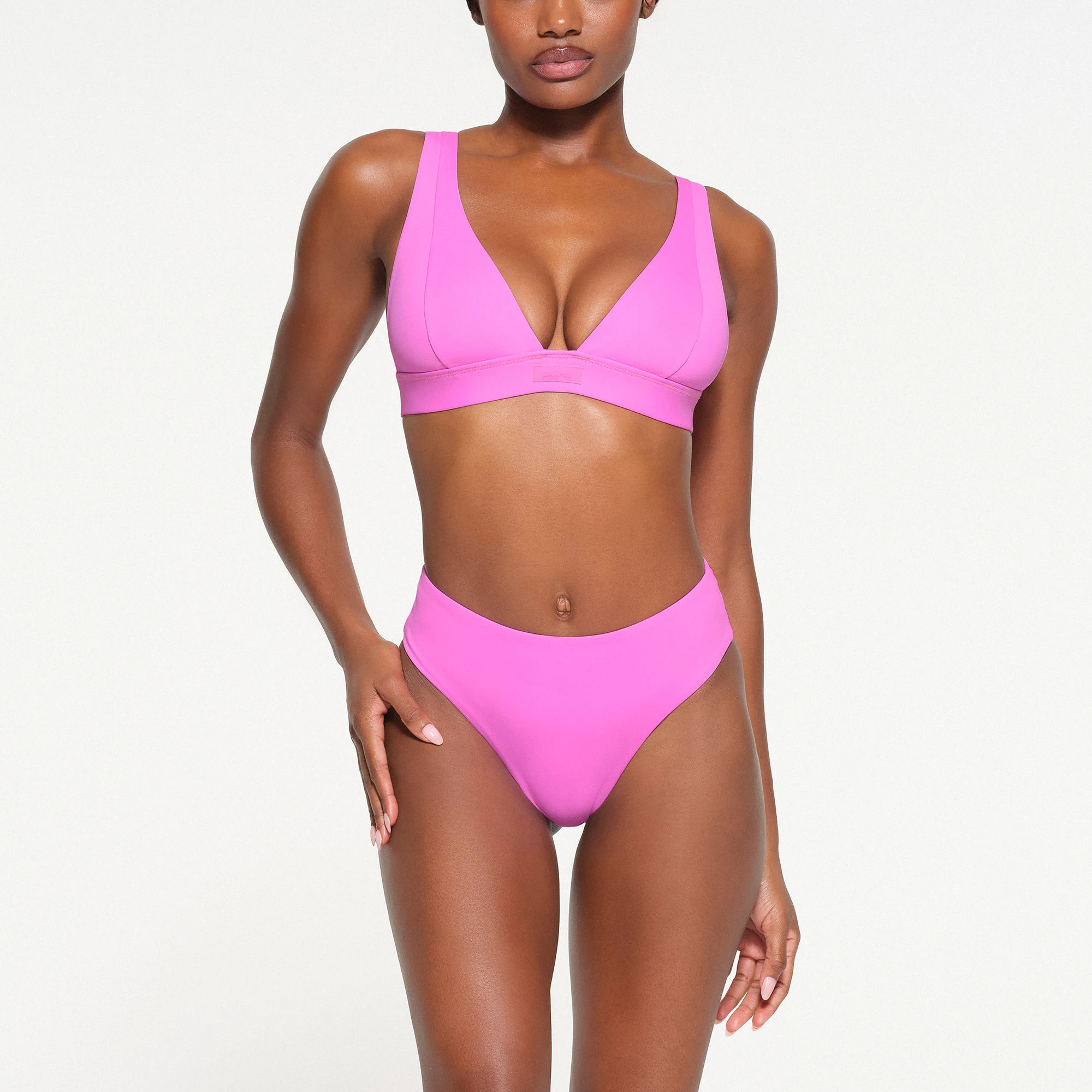 SIGNATURE SWIM PLUNGE BIKINI TOP | NEON ORCHID ON A MODEL FRONT VIEW
