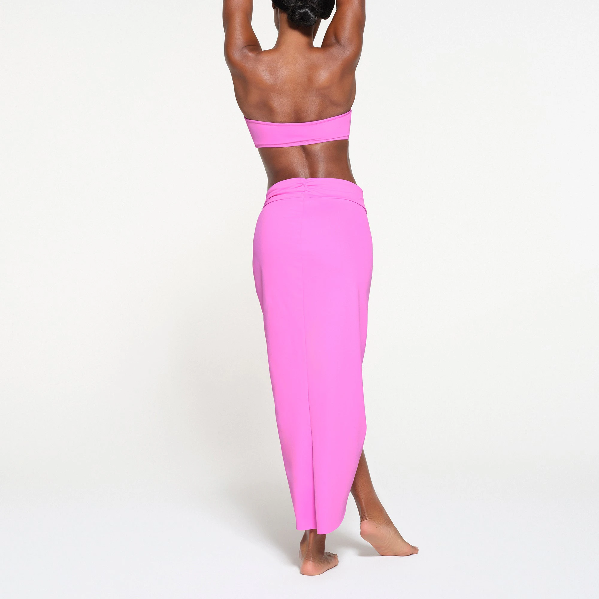 SIGNATURE SWIM SARONG SKIRT | NEON ORCHID ON A MODEL BACK VIEW