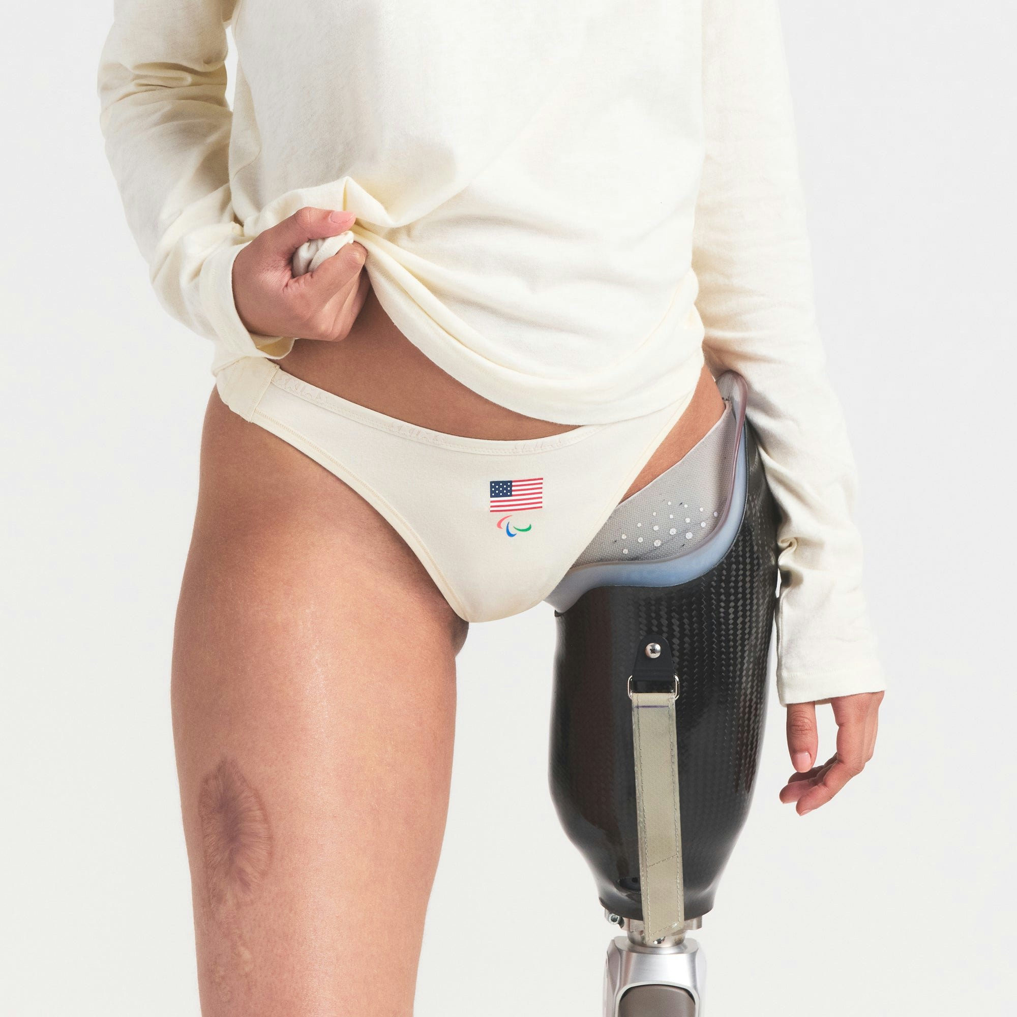 SKIMS FOR TEAM USA COTTON JERSEY PARALYMPIC THONG 3-PACK | SKIMS FOR TEAM USA OLYMPIC MULTI ON A MODEL SIDE VIEW @ | FOCUS: 0.0, 1.0, 0.9