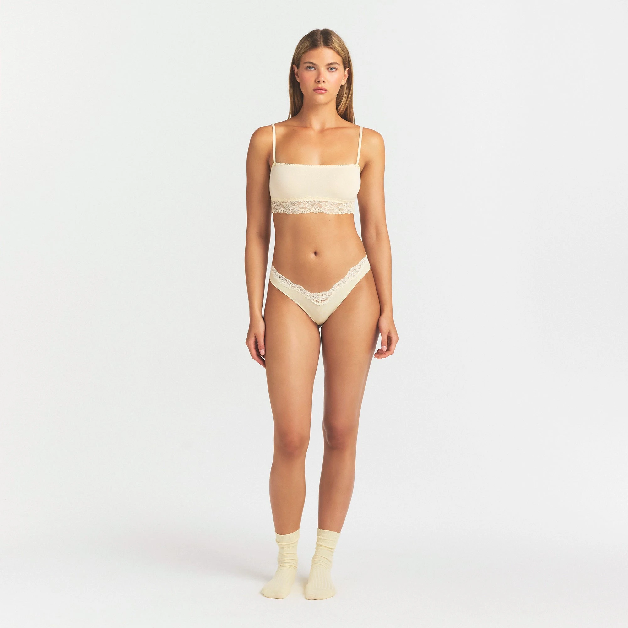 LIGHTWEIGHT COTTON LACE THONG | BUTTER TONAL ON A MODEL FRONT VIEW @ | FOCUS: 0.0, 1.0, 0.9