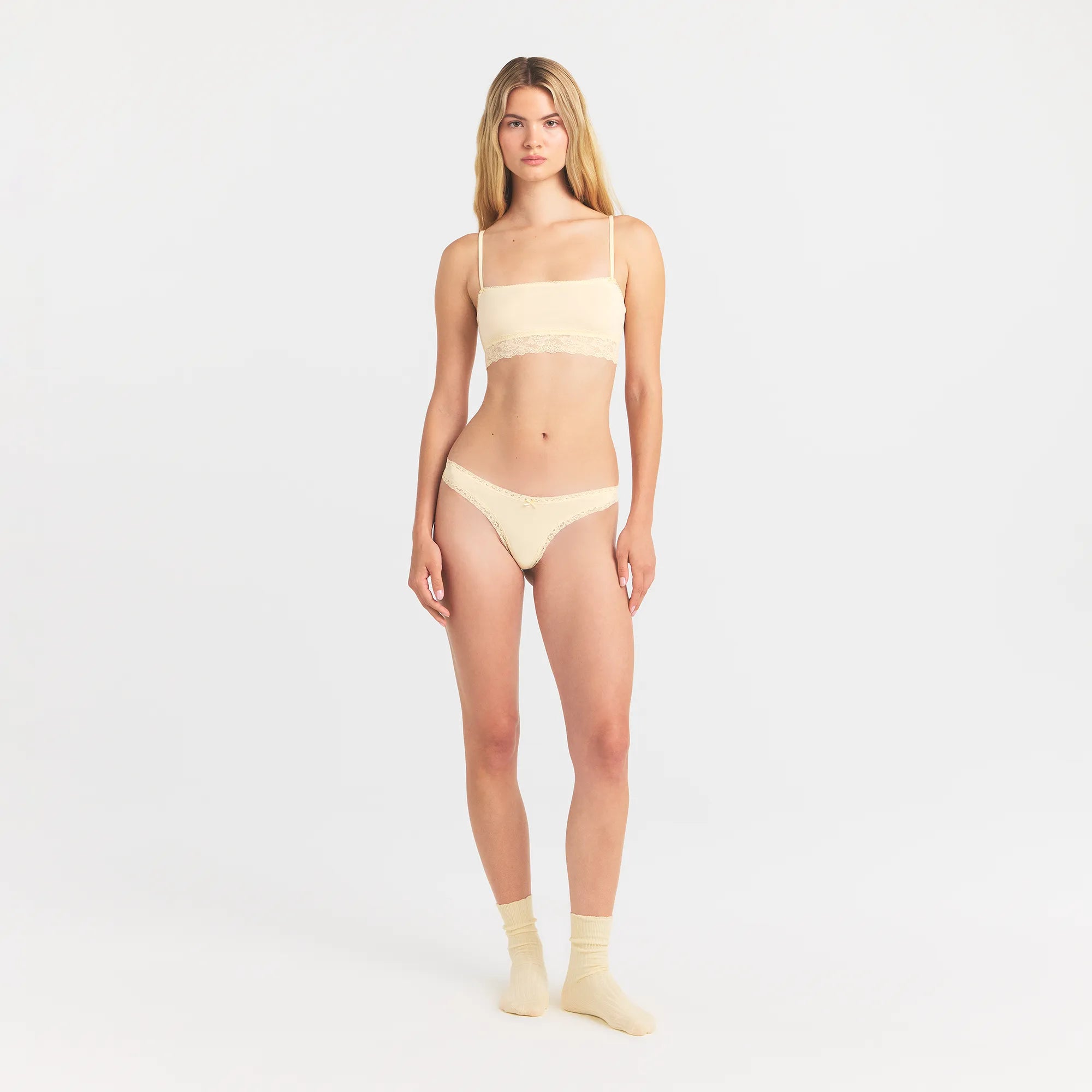 LIGHTWEIGHT COTTON LACE THONG | BUTTER TONAL ON A MODEL FRONT VIEW @ | FOCUS: 0.0, 1.0, 0.9