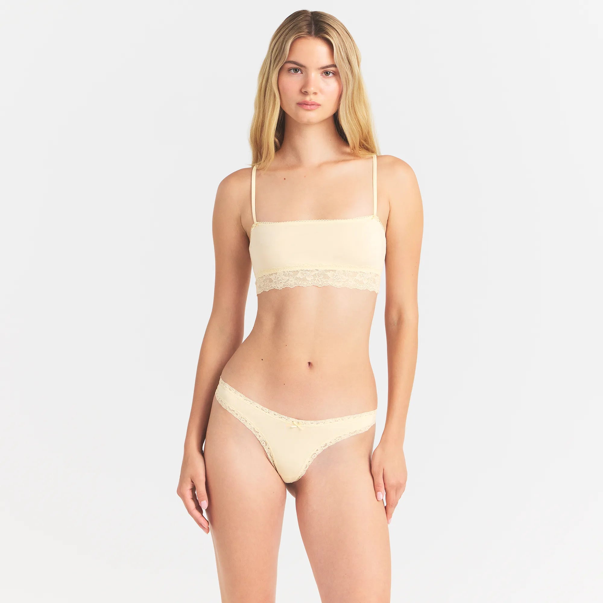 LIGHTWEIGHT COTTON LACE THONG | BUTTER TONAL ON A MODEL FRONT VIEW @ | FOCUS: 0.0, 1.0, 0.9