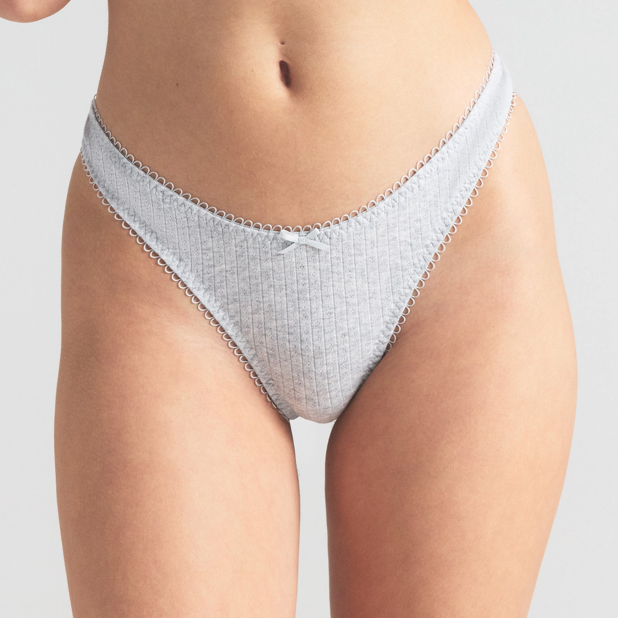 POINTELLE DIPPED THONG | LIGHT HEATHER GREY ON A MODEL SIDE VIEW | FOCUS: 0.0, 1.0, 0.9