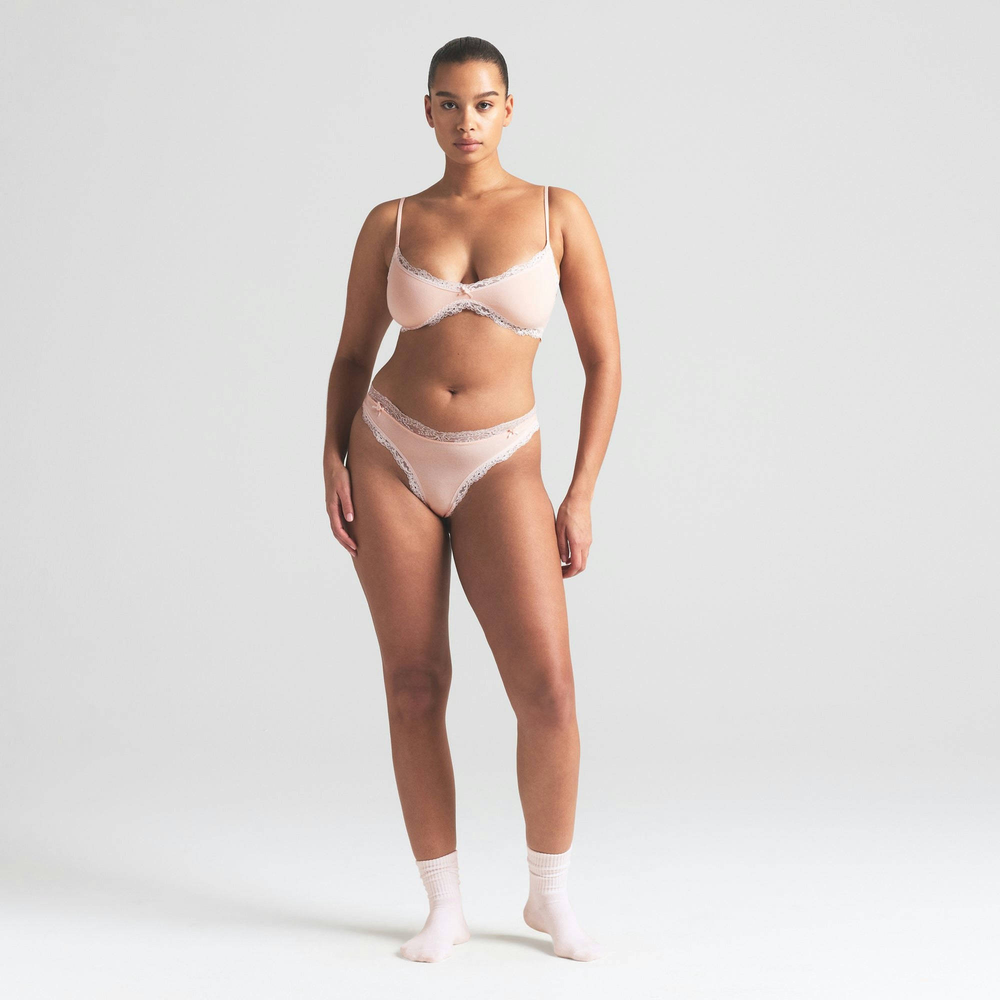 COTTON JERSEY LACE THONG | PRIMROSE ON A MODEL FRONT VIEW | FOCUS: 0.0, 1.0, 0.9