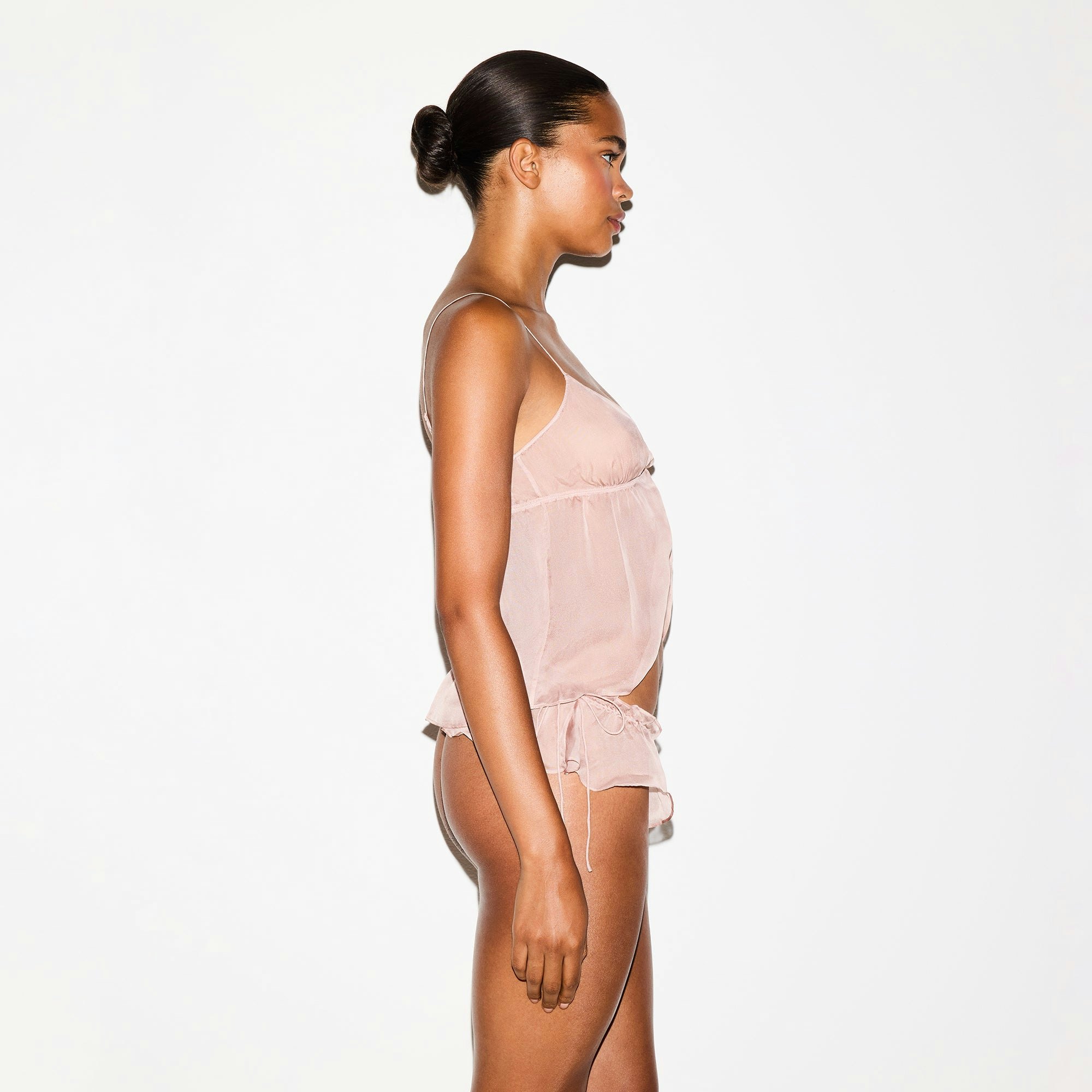 SKIMS ROMANCE BABYDOLL TOP | LIGHT FAWN ON A MODEL SIDE VIEW @ | FOCUS: 0.0, 1.0, 0.9