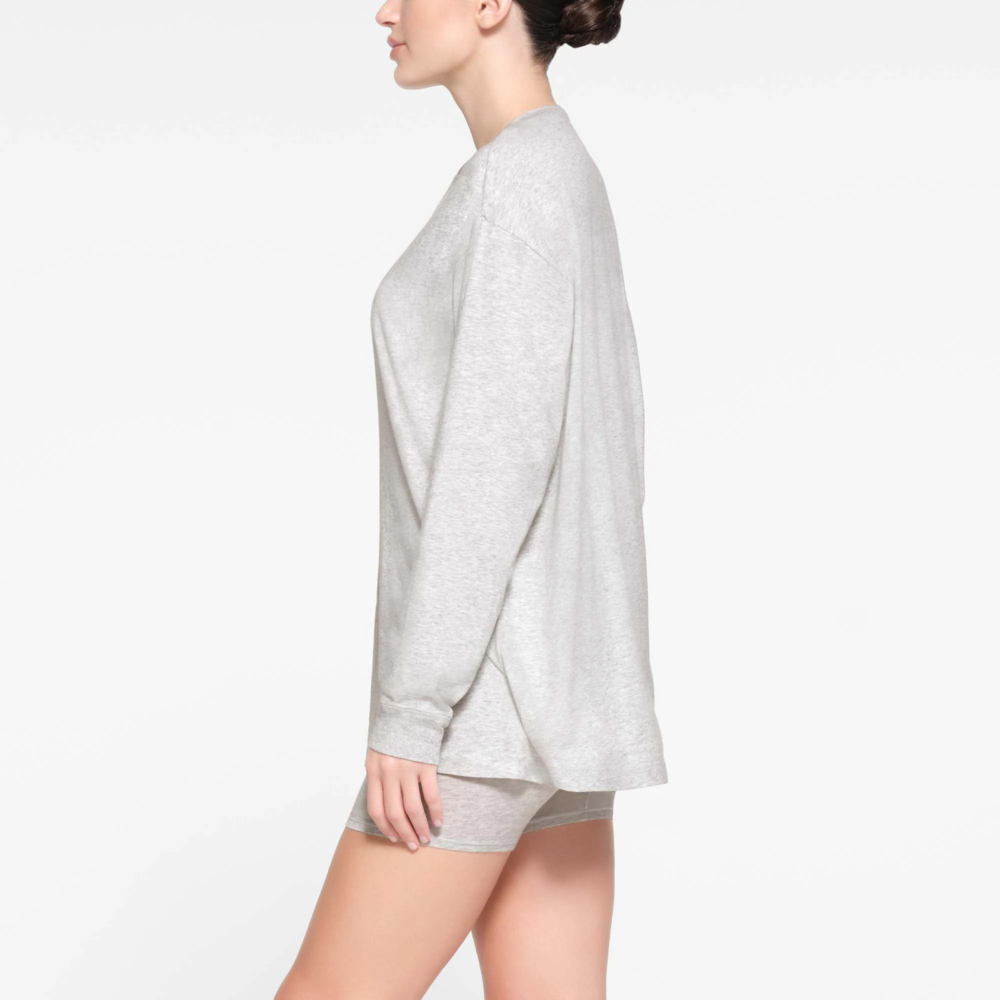 BOYFRIEND LONG SLEEVE HENLEY | LIGHT HEATHER GREY ON A MODEL SIDE VIEW