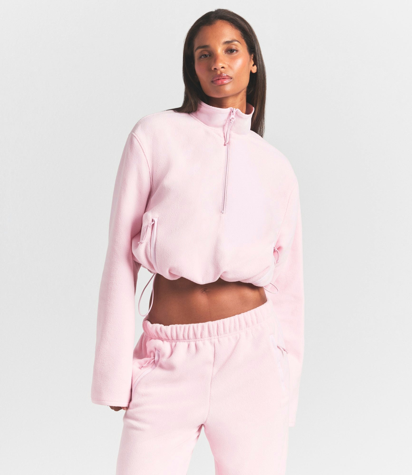 OUTDOOR FLEECE HALF ZIP PULLOVER | CHERRY BLOSSOM ON A MODEL SIDE VIEW @ | FOCUS: 0.0, 1.0, 0.9