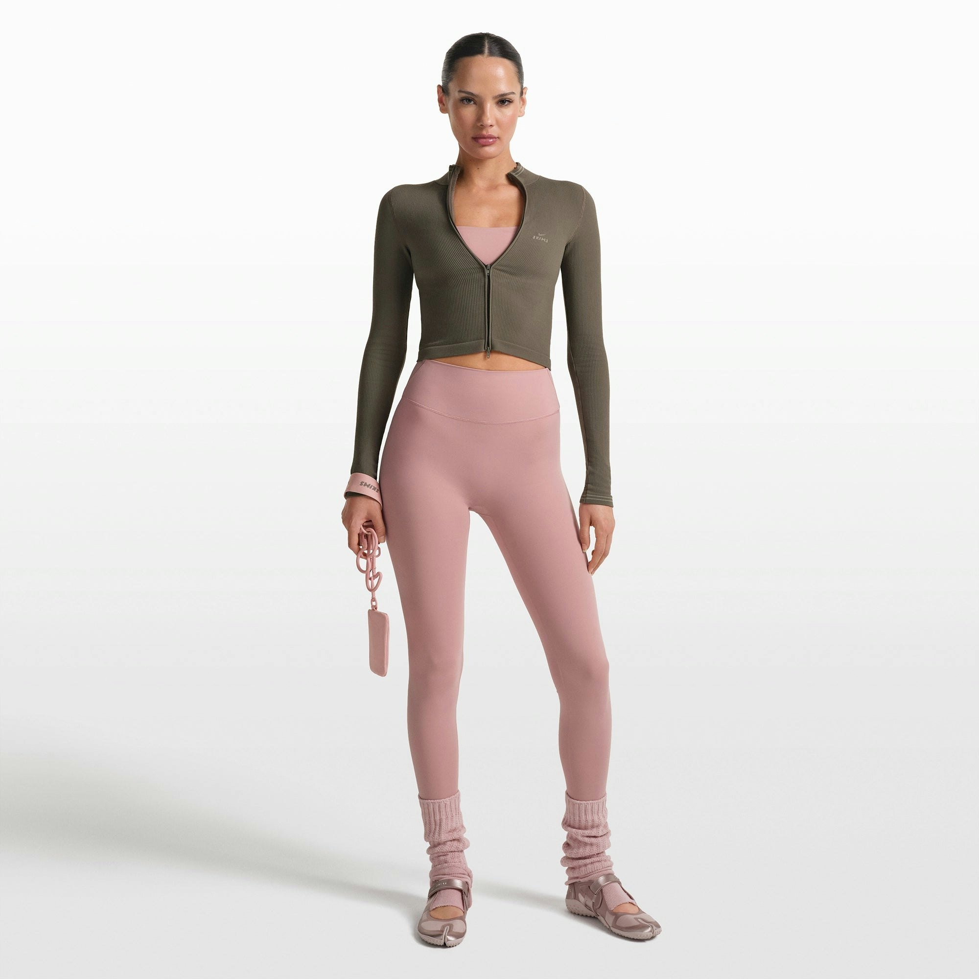 NikeSKIMS RIBBED SEAMLESS ZIP UP CROP JACKET | DUSTY OAKMOSS ON A MODEL FRONT VIEW @ | FOCUS: 0.0, 1.0, 0.9