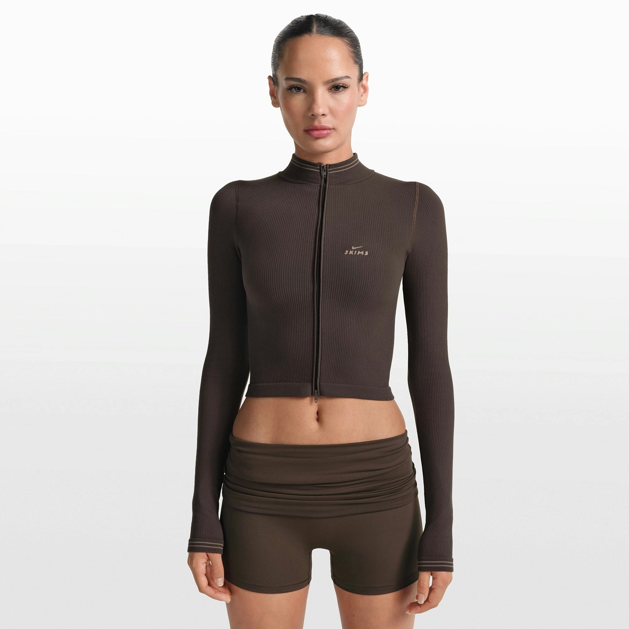 NikeSKIMS RIBBED SEAMLESS ZIP UP CROP JACKET | PHOENIX/TRUFFLE ON A MODEL FRONT VIEW @ | FOCUS: 0.0, 1.0, 0.9