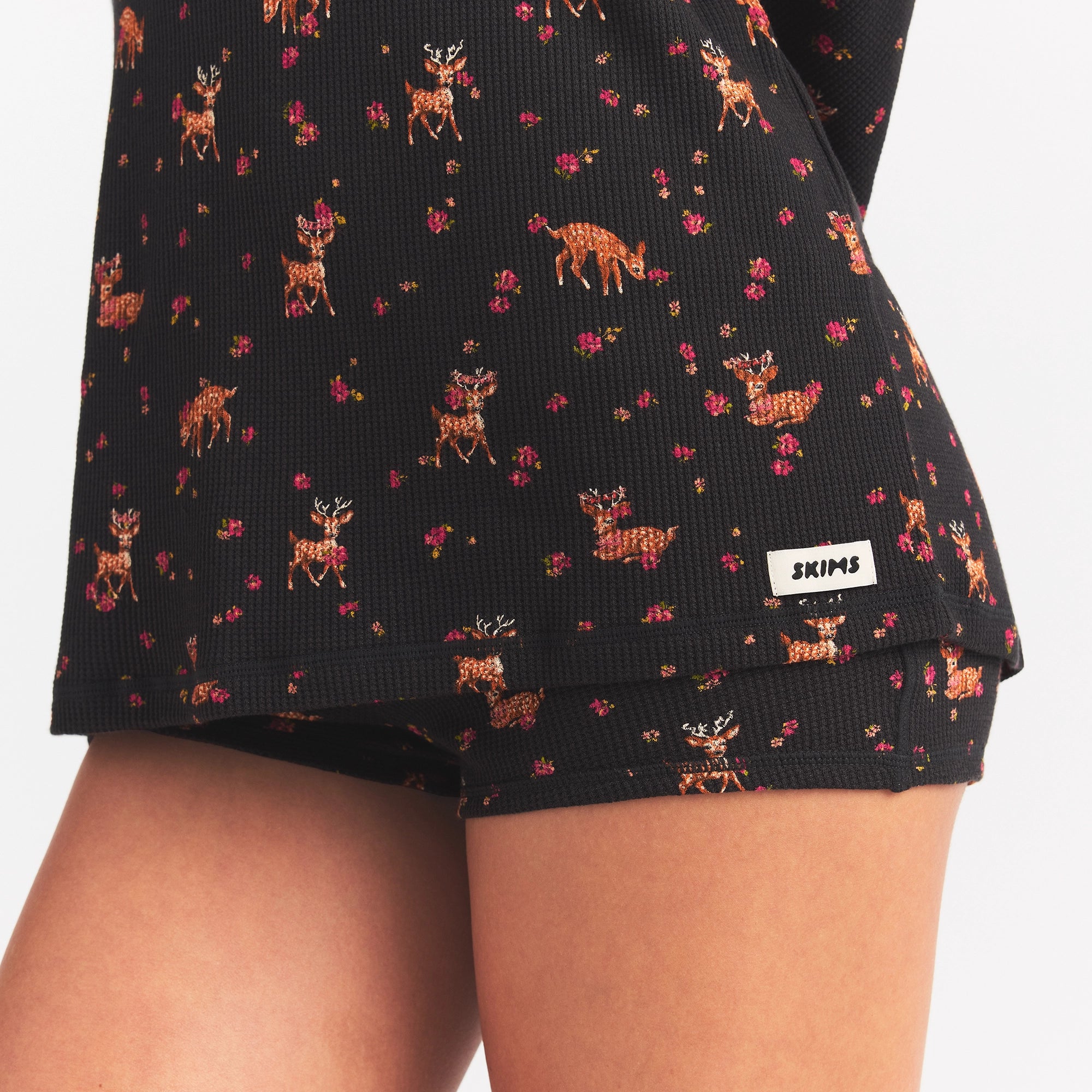 WAFFLE OVERSIZED LONG SLEEVE TOP | ONYX FLORAL DEER PRINT ON A MODEL SIDE VIEW @ | FOCUS: 0.0, 1.0, 0.9